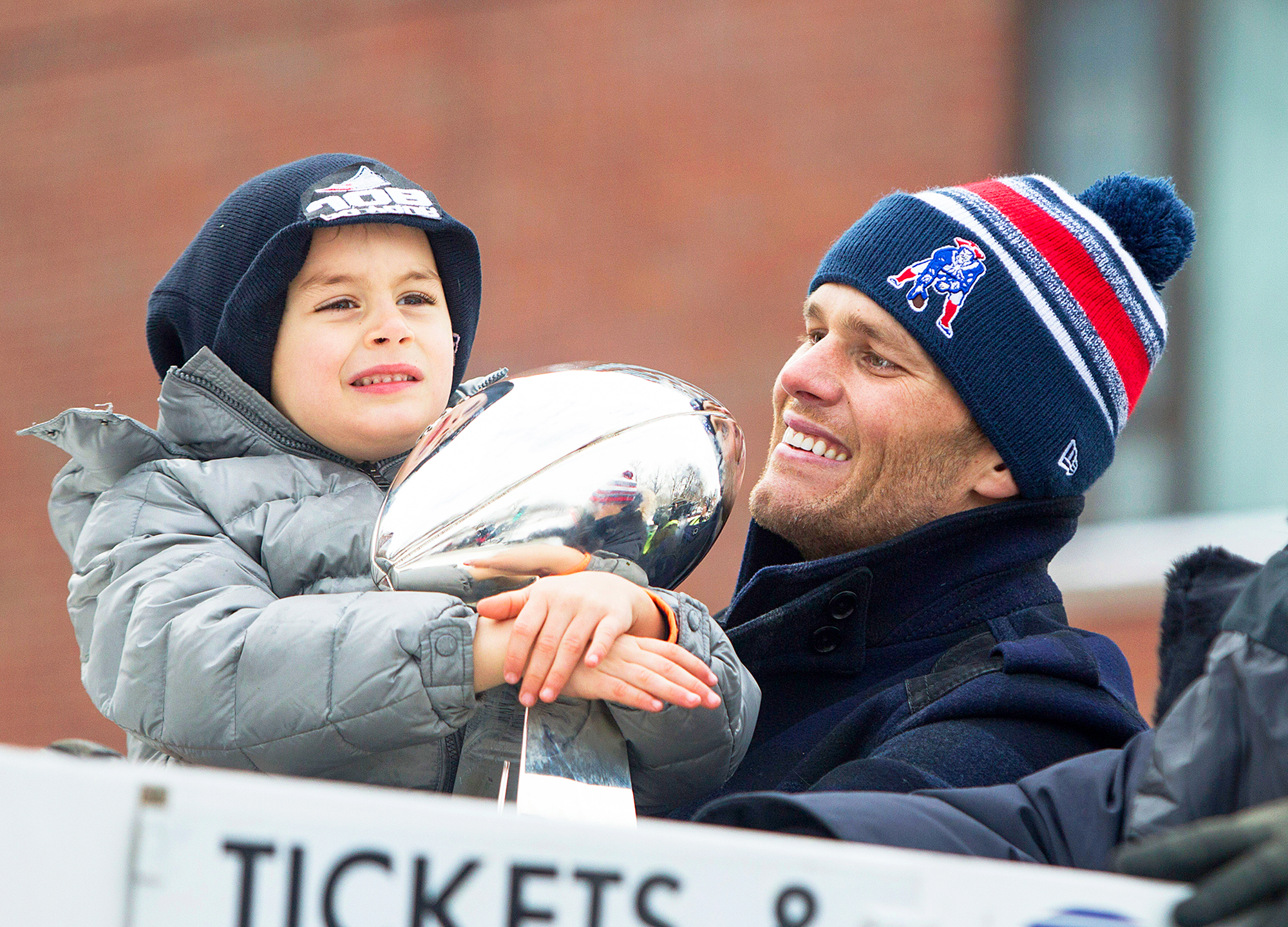 Tom Brady and son Benjamin holds the Lombardi trophy during the New England Patriots Victory 2015 Parade in Boston, Massachusetts.