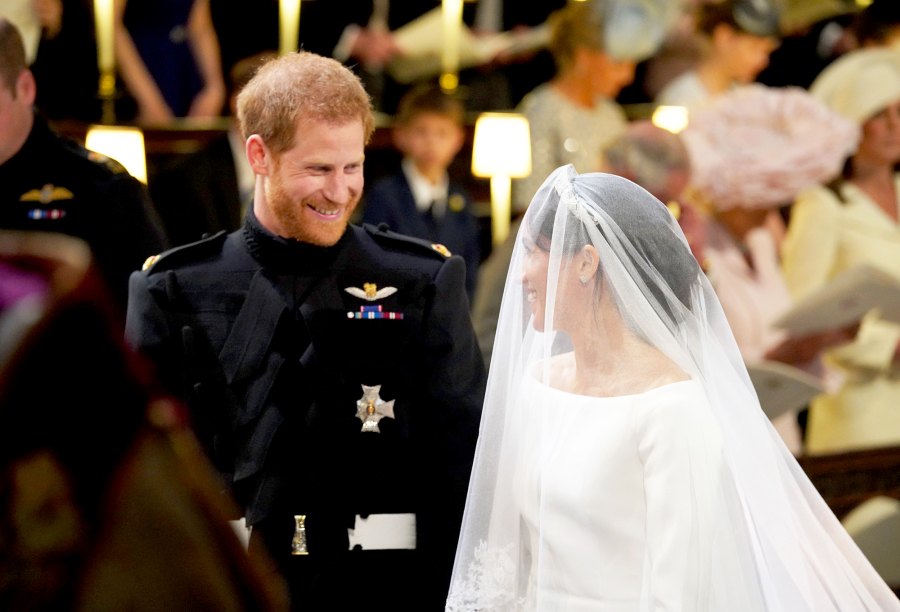 Prince Harry looks at his bride, Meghan Markle, as she arrived accompanied by Prince Charles, Prince of Wales during their wedding in St George's Chapel at Windsor Castle on May 19, 2018 in Windsor, England.