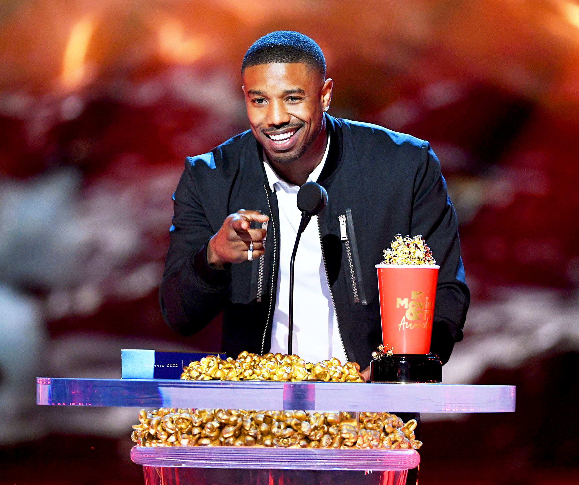 Michael B. Jordan accepts the Best Villain award for 'Black Panther' onstage during the 2018 MTV Movie And TV Awards at Barker Hangar on June 16, 2018 in Santa Monica, California.