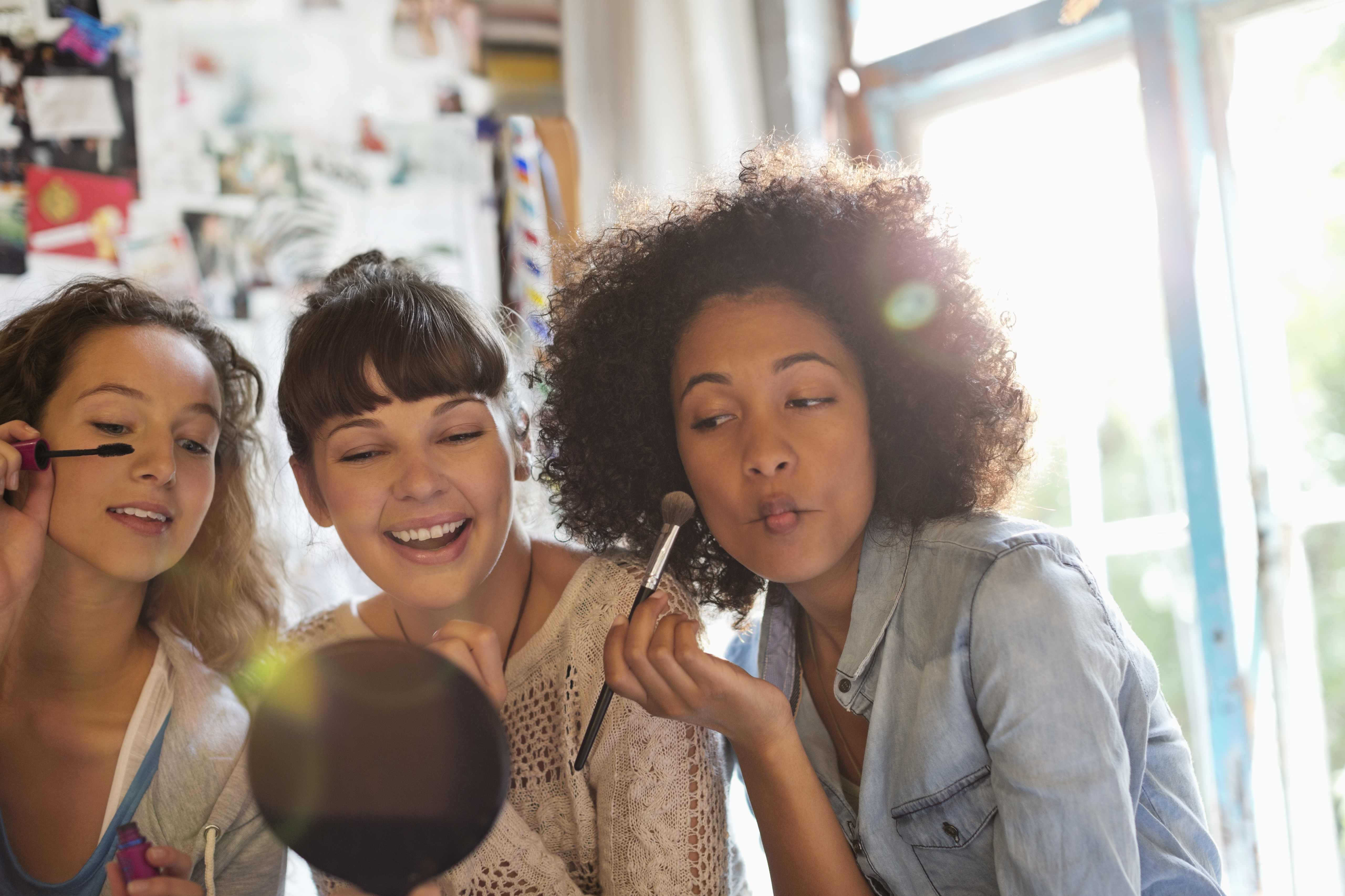 women applying makeup