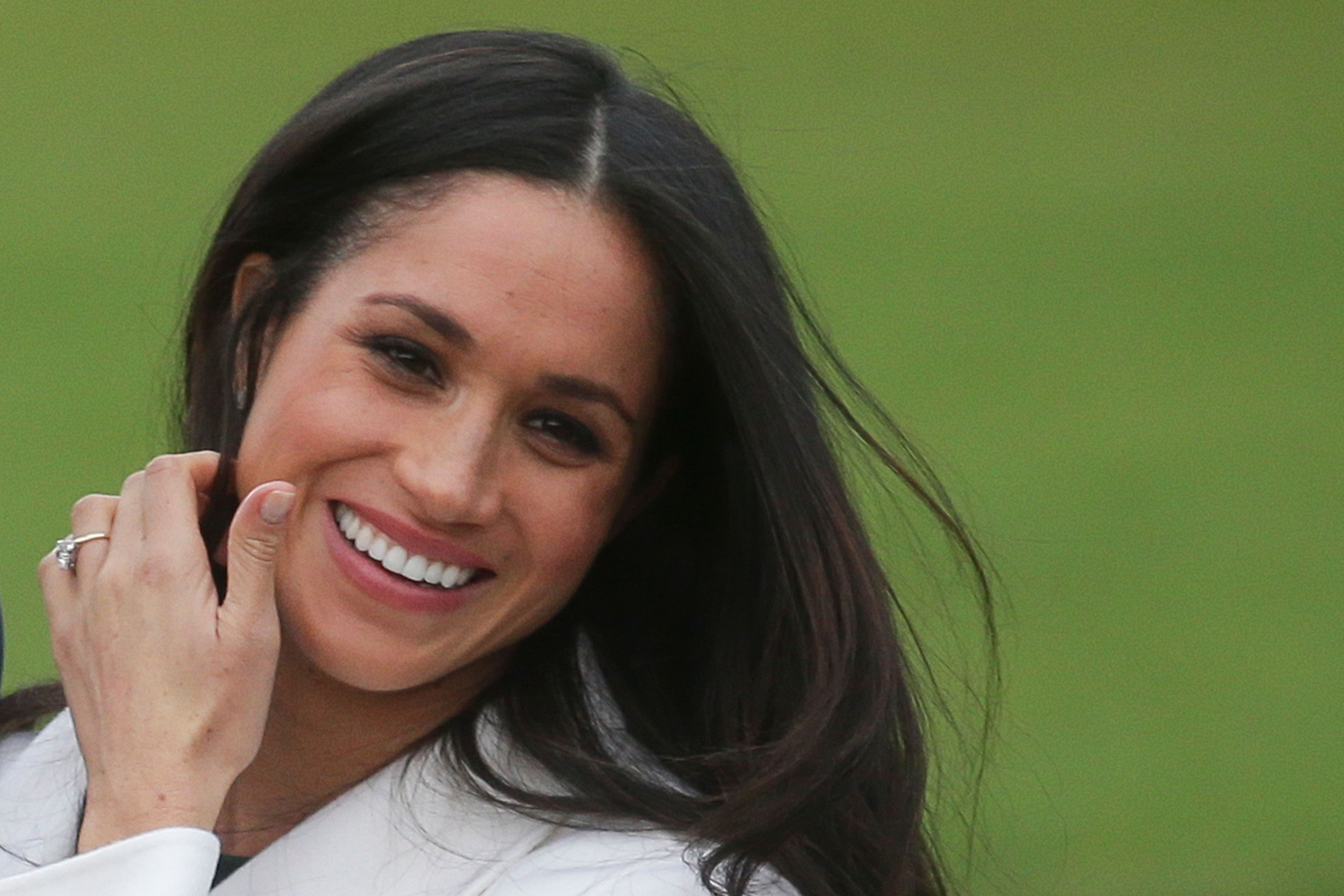US actress Meghan Markle shows off her engagement ring she poses with her fiancée Britain's Prince Harry in the Sunken Garden at Kensington Palace in west London on November 27, 2017, following the announcement of their engagement. - Britain's Prince Harry will marry his US actress girlfriend Meghan Markle early next year after the couple became engaged earlier this month, Clarence House announced on Monday. (Photo by Daniel LEAL-OLIVAS / AFP) (Photo credit should read DANIEL LEAL-OLIVAS/AFP/Getty Images)