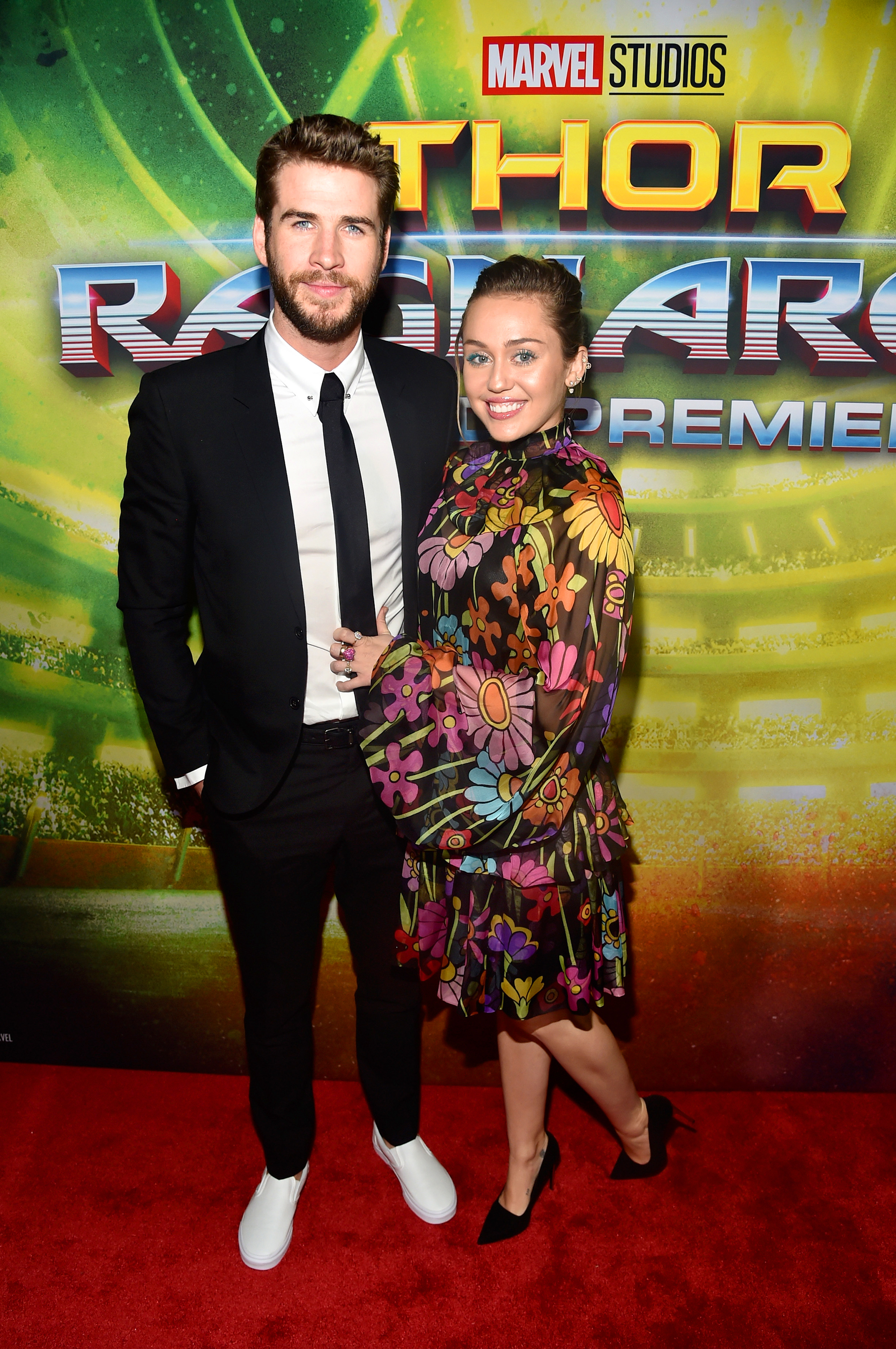 Liam Hemsworth (L) and Miley Cyrus