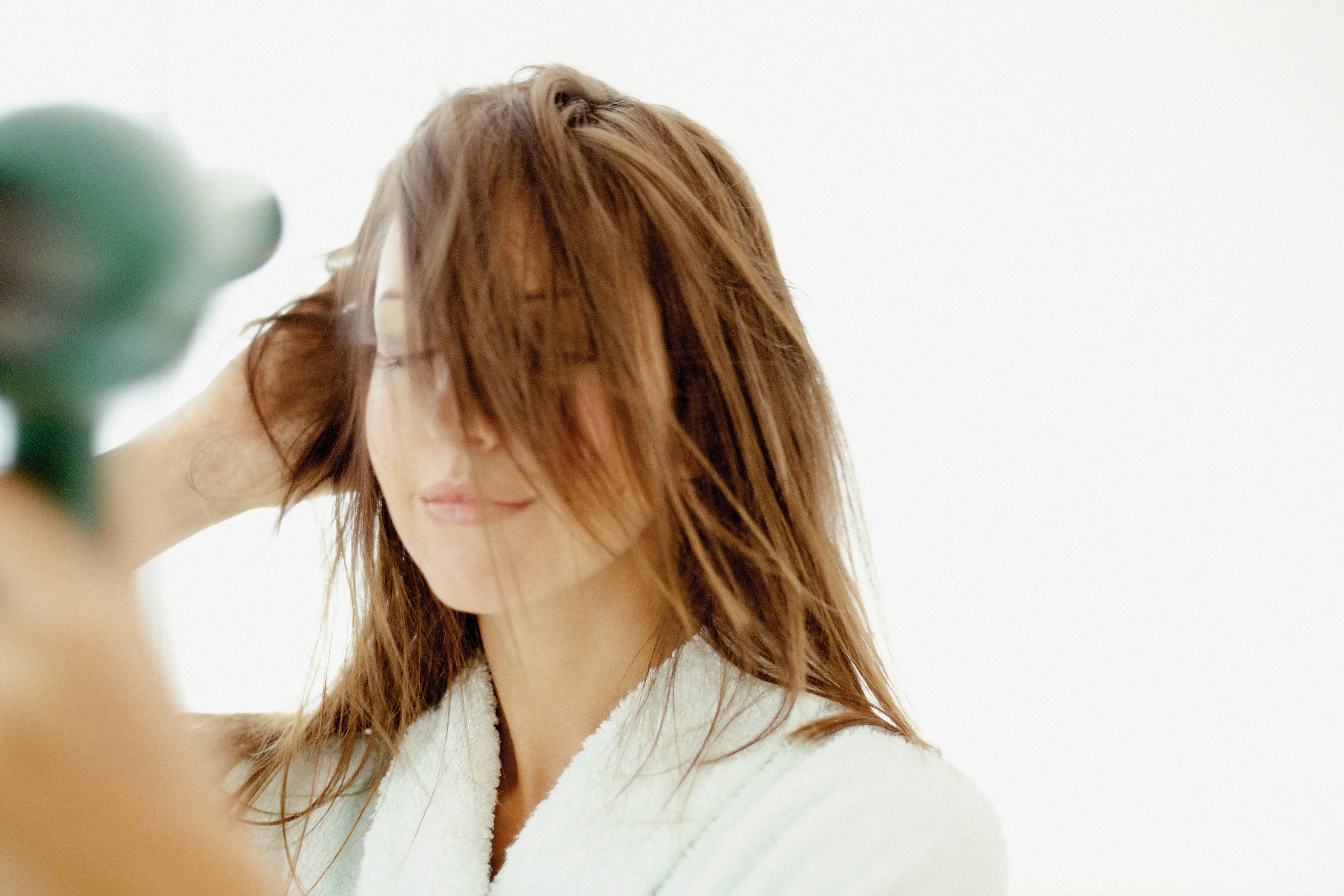 Woman blow-drying hair