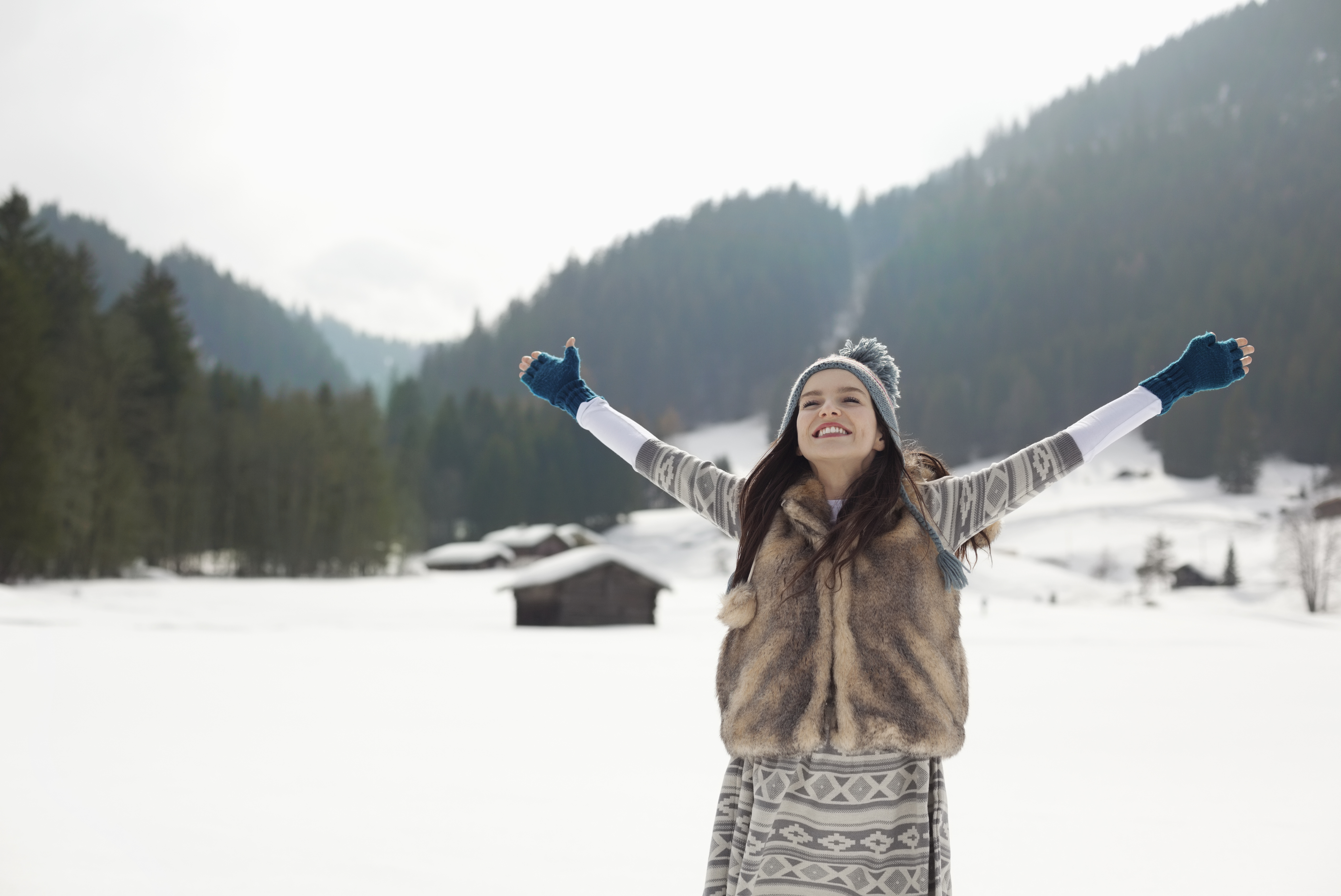 woman in the snow wearing a fur vest