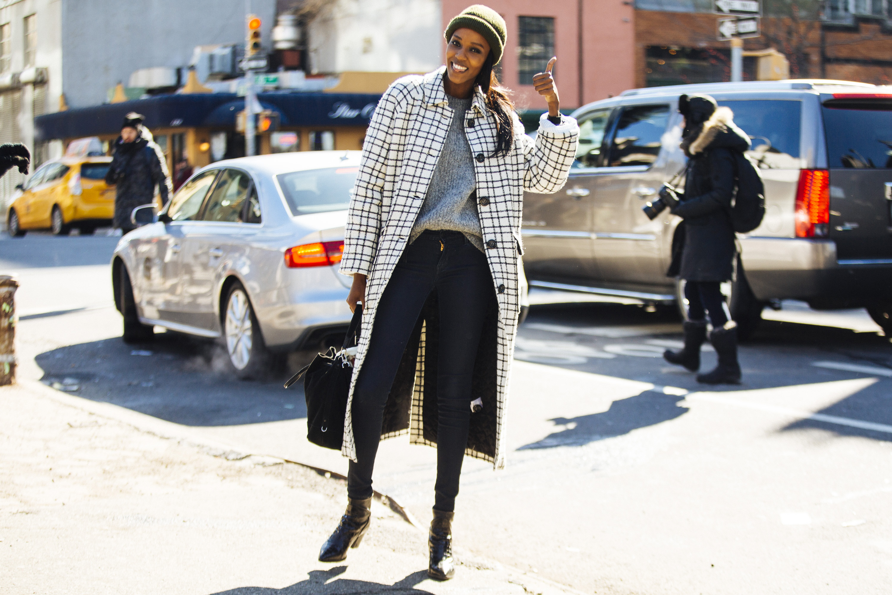 model in skinny jeans and checkered coat