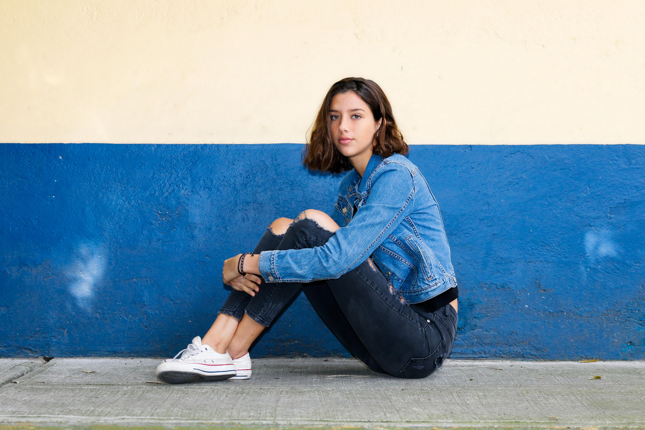 girl in a pair of jeans and a denim jacket
