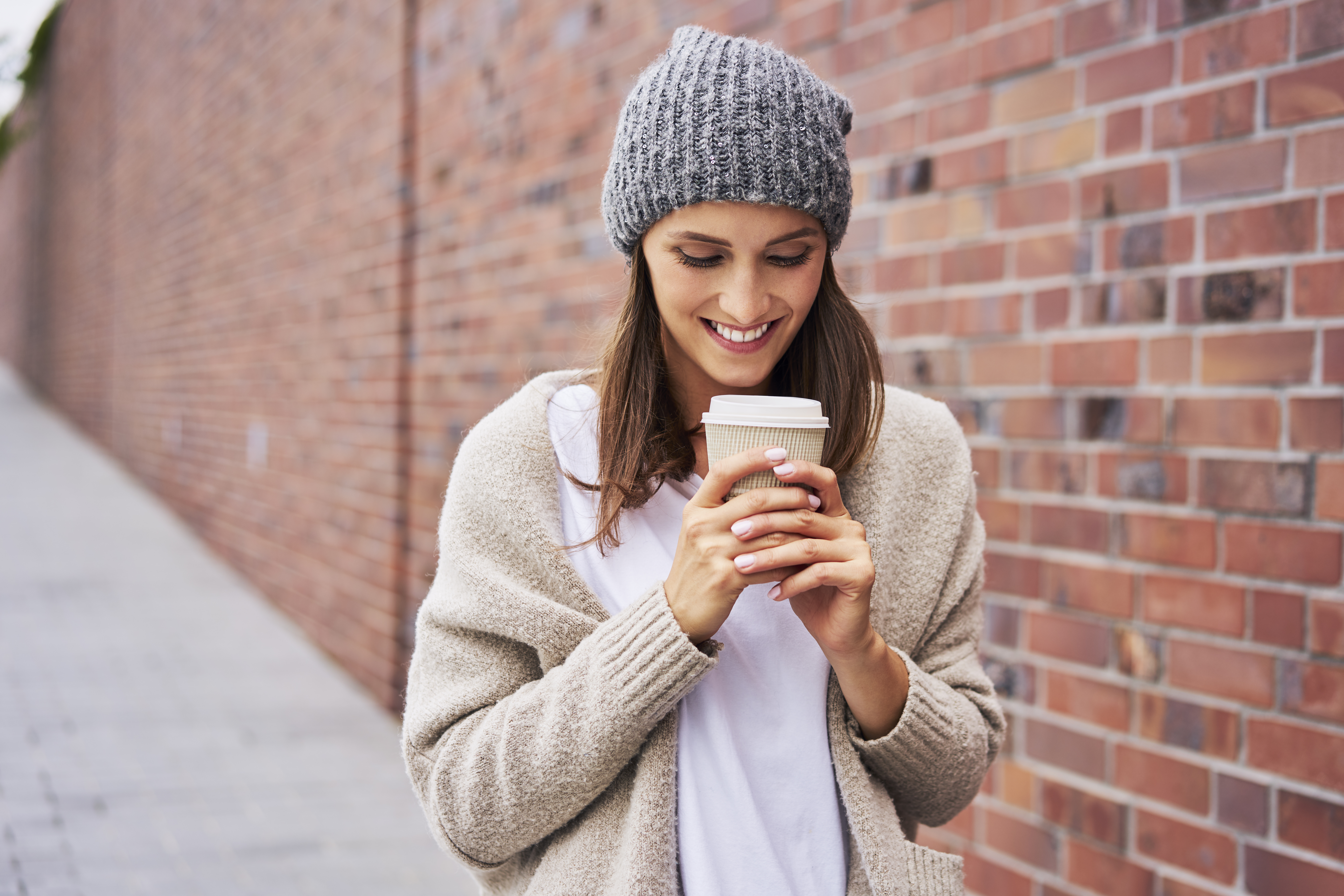 Happy woman with coffee to go