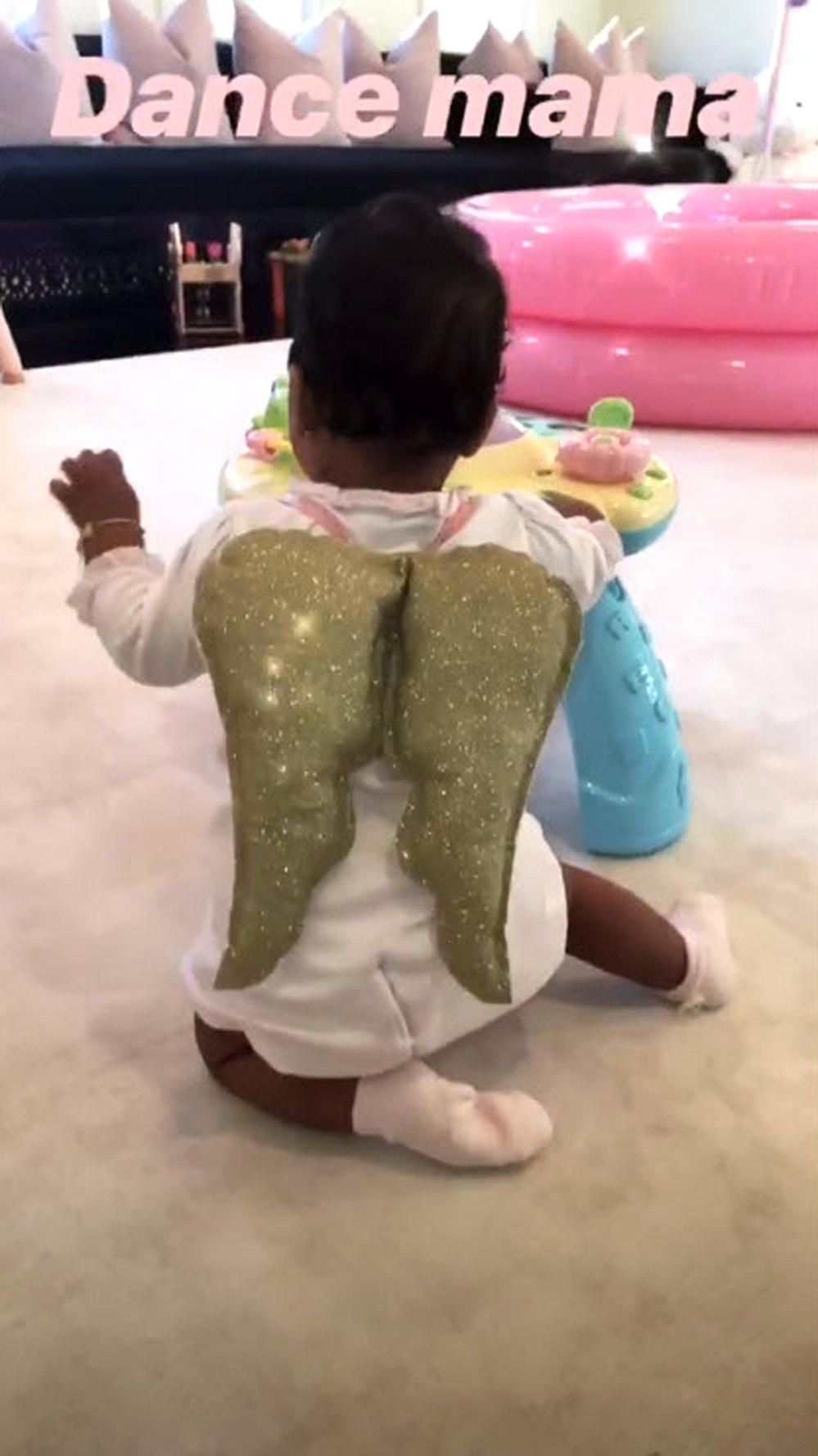 khloe kardashian shares videos of true wearing gold angel wings, playing with Christmas toys