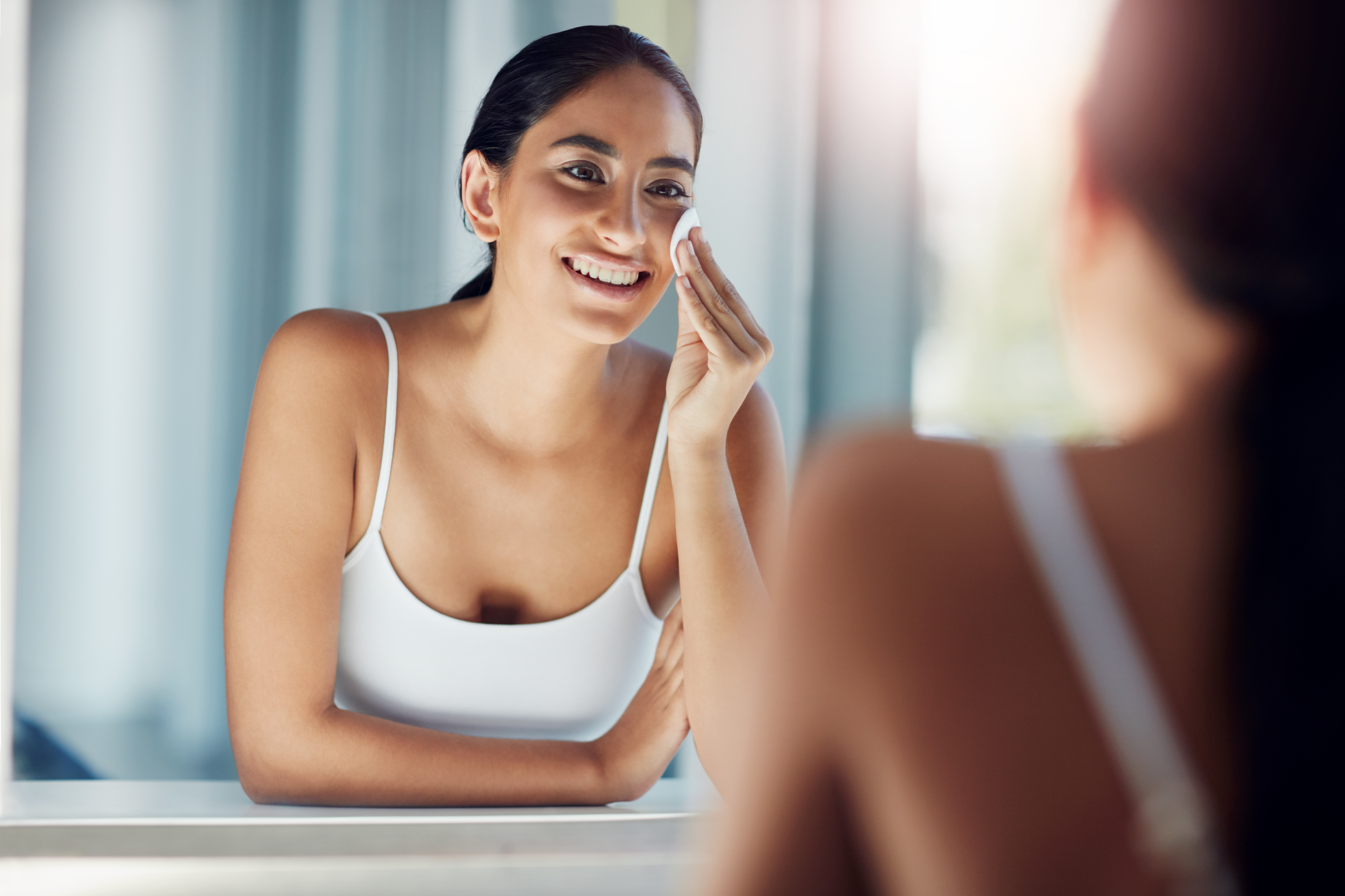 woman cleansing face
