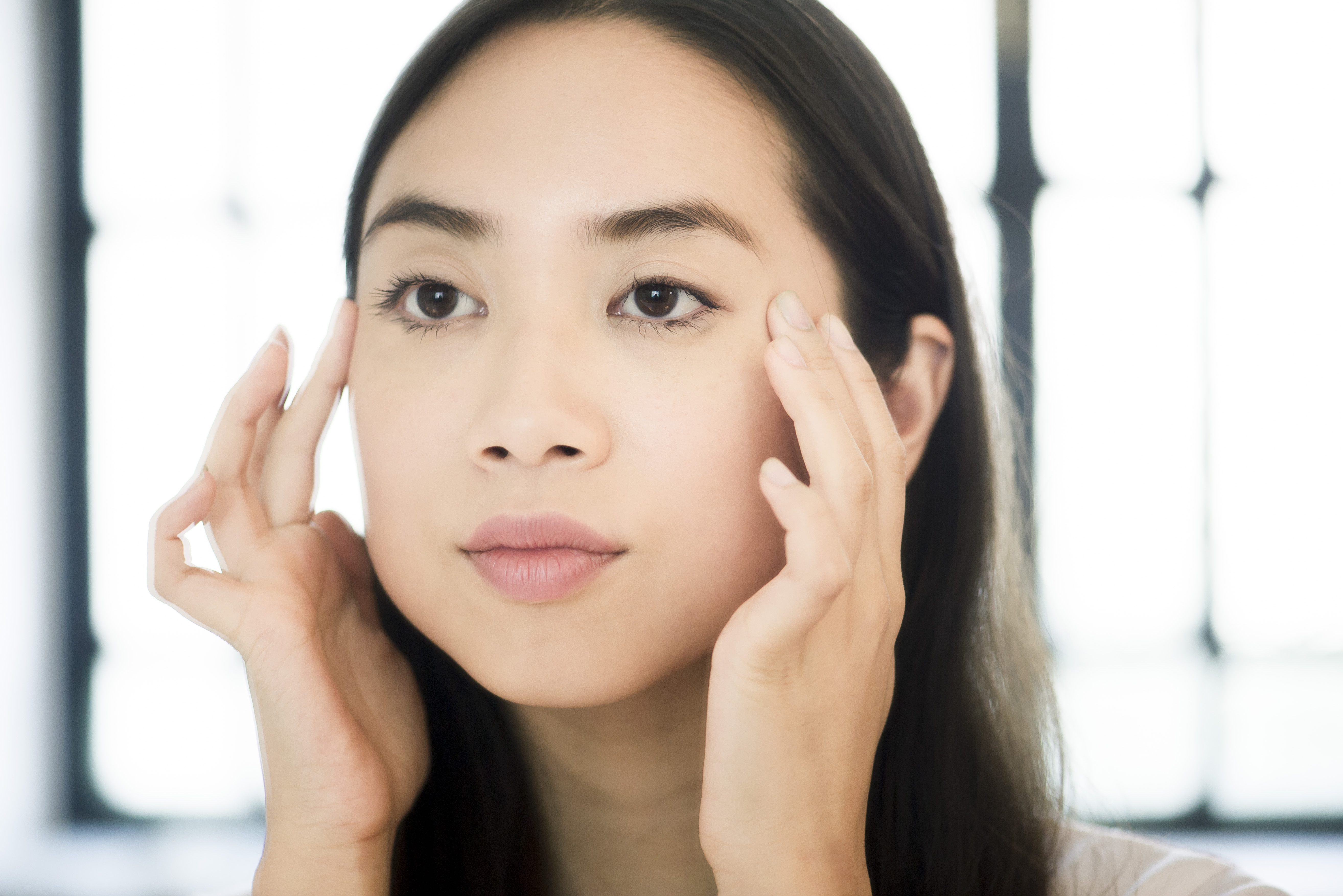 woman massaging face