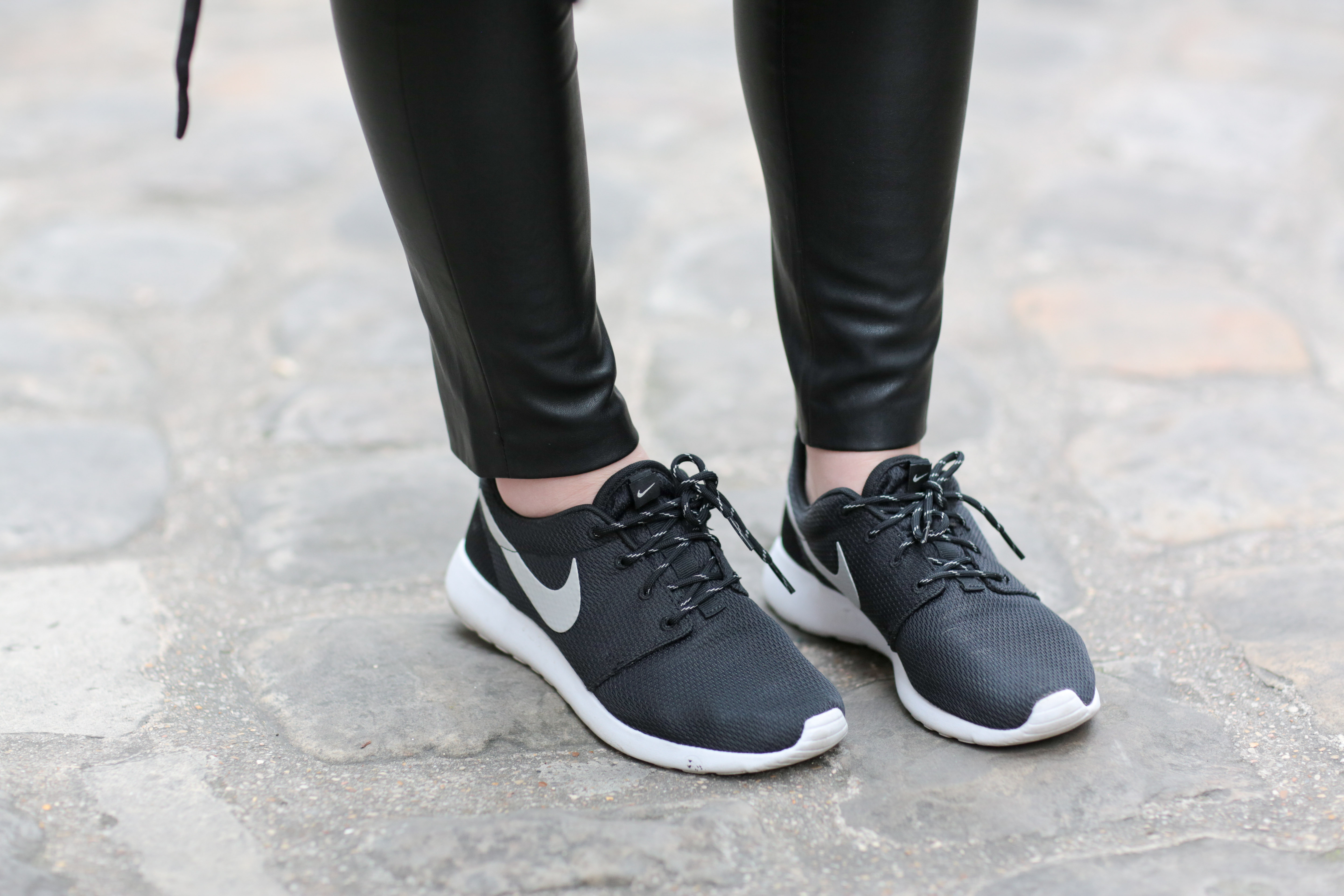 woman in nike roshe sneakers