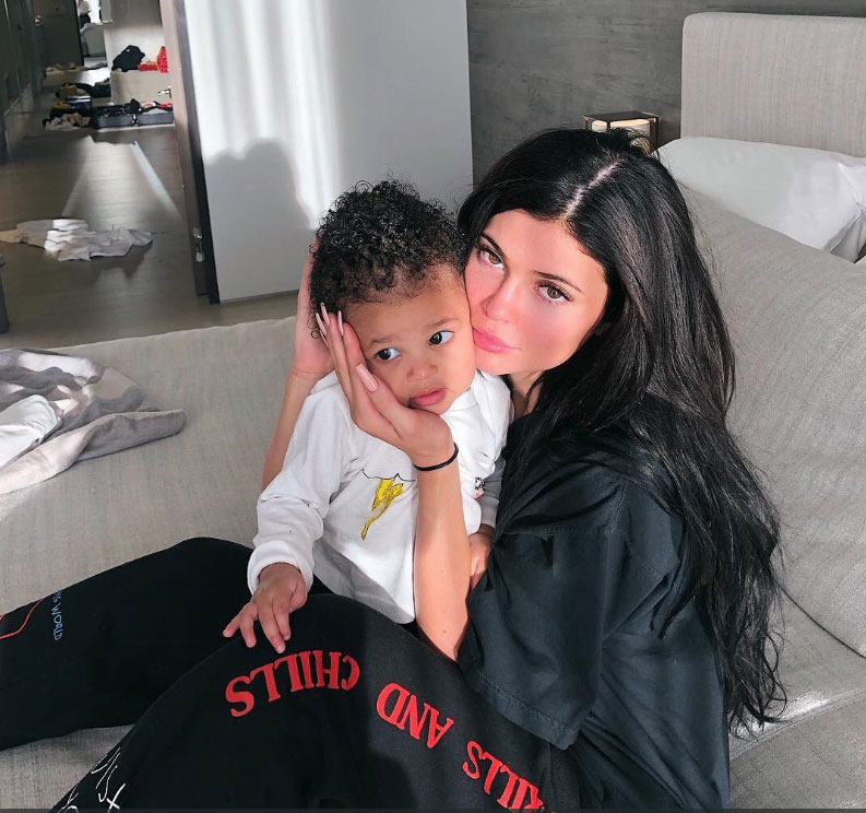 Kylie Jenner Shows Support for Travis Scott While Cuddling Stormi