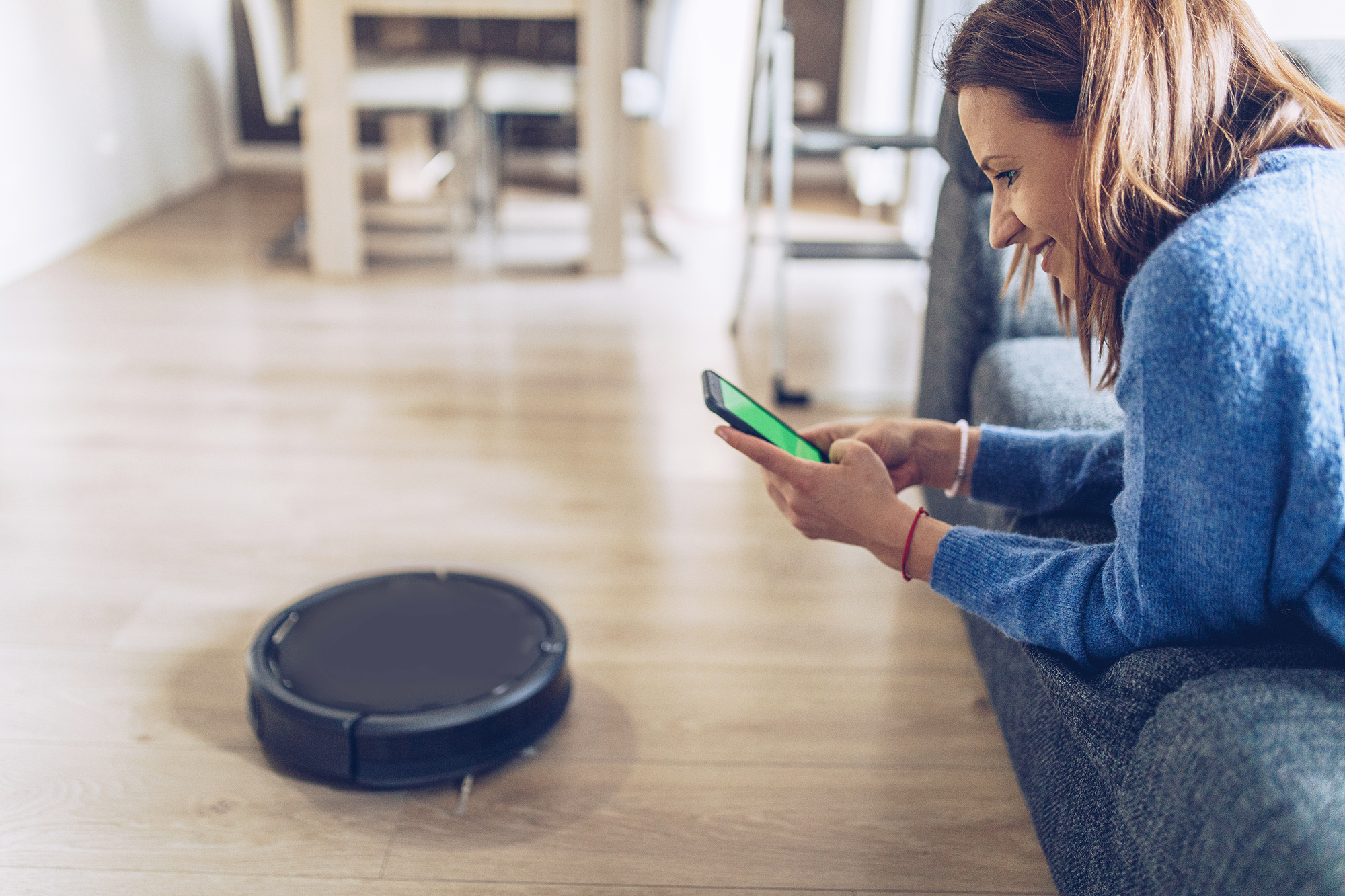 Woman Using Robot Vacuum