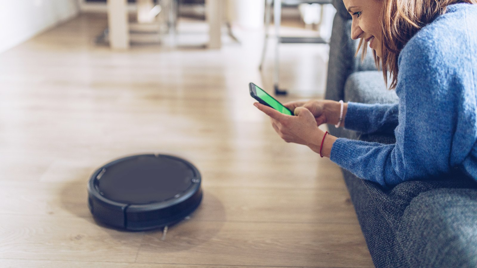 Woman Using Robot Vacuum