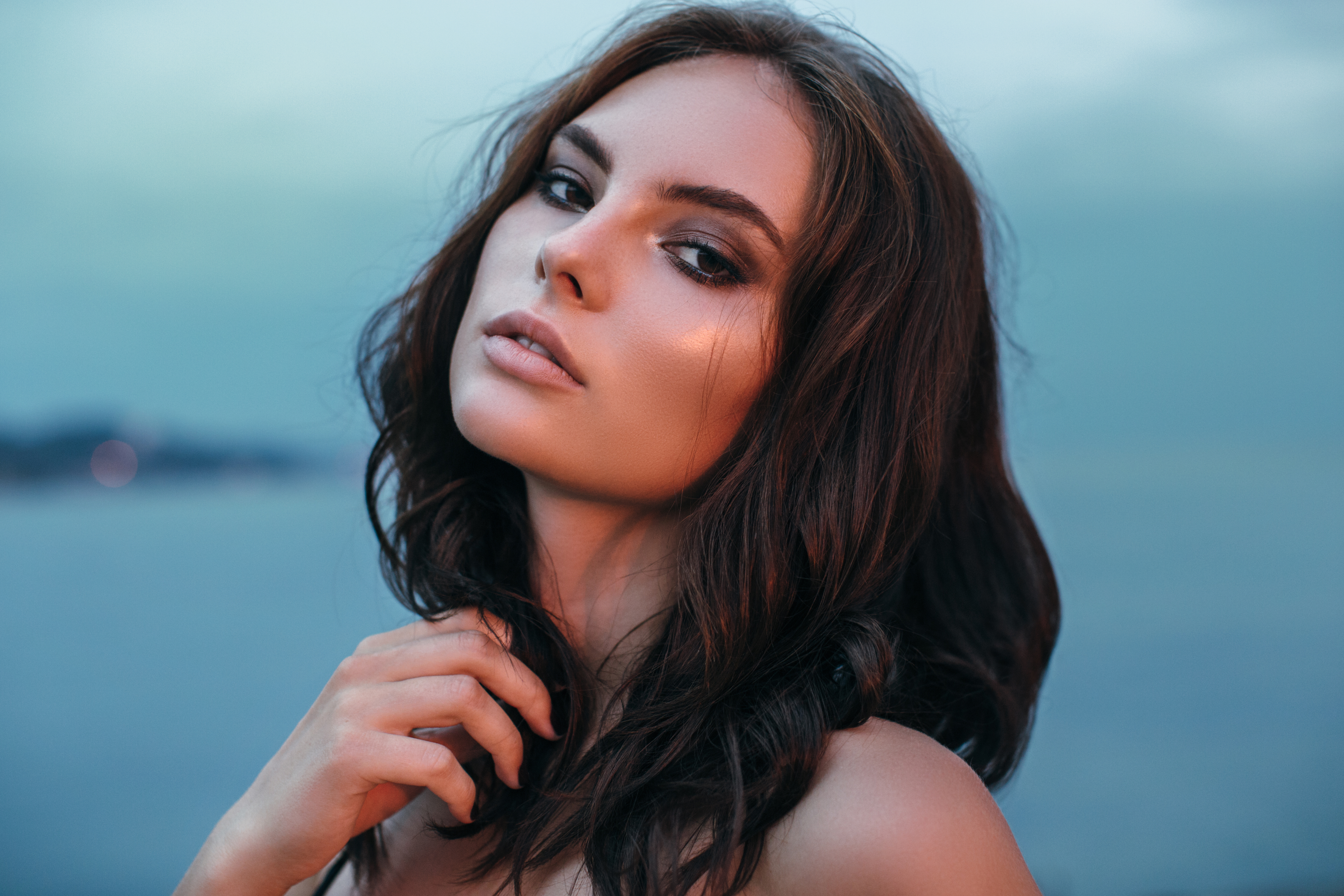 Portrait of a fresh and lovely woman posing at the beach