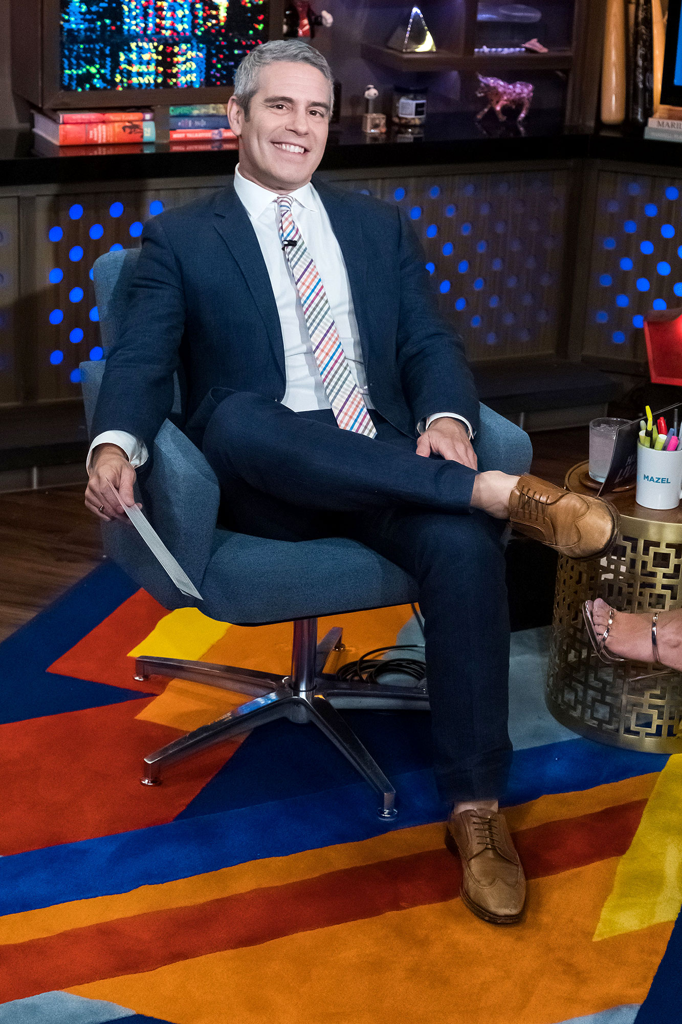 Andy Cohen Sitting in a Chair For His Show Watch What Happens Live With Andy Cohen