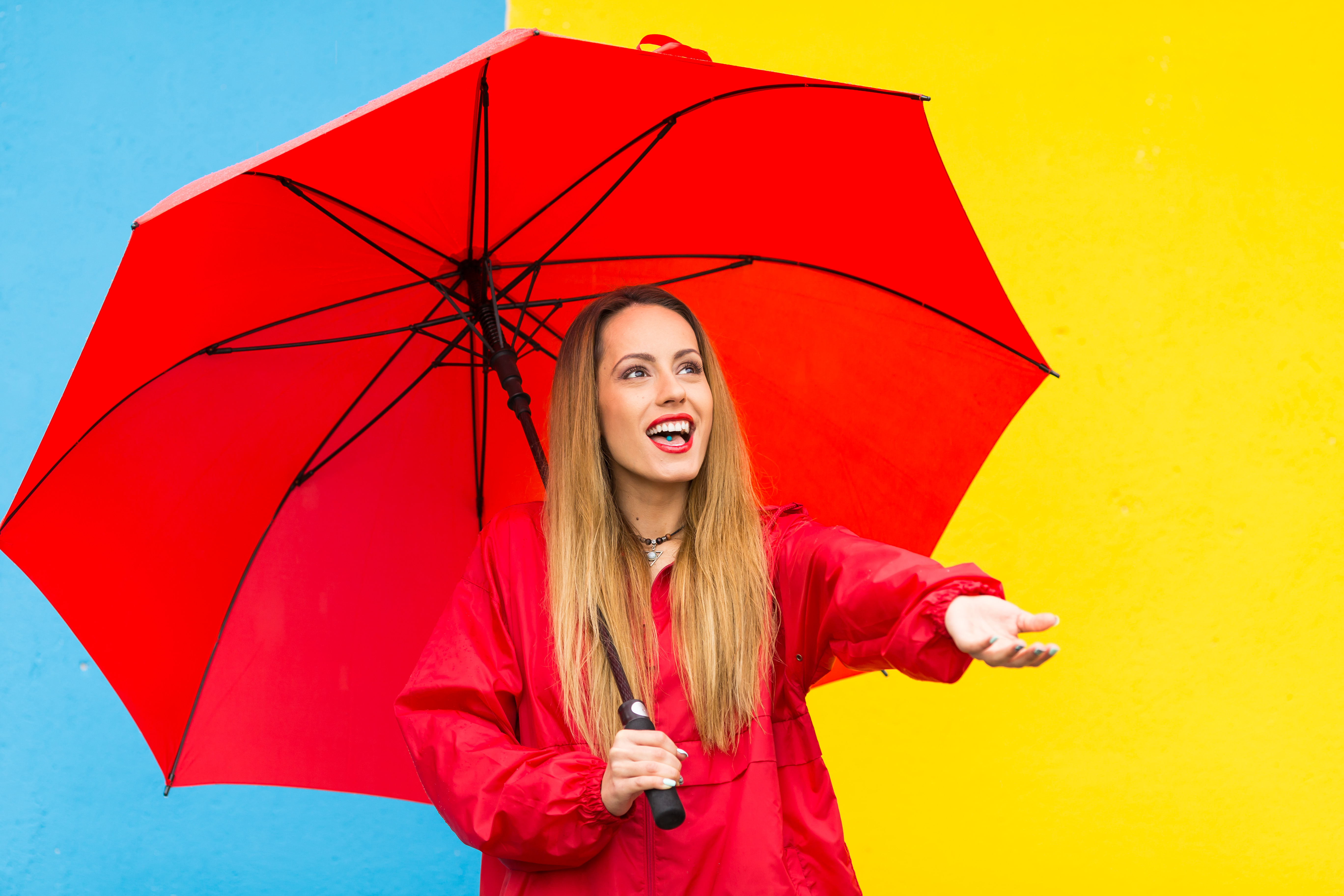 Young woman holding red umbrella