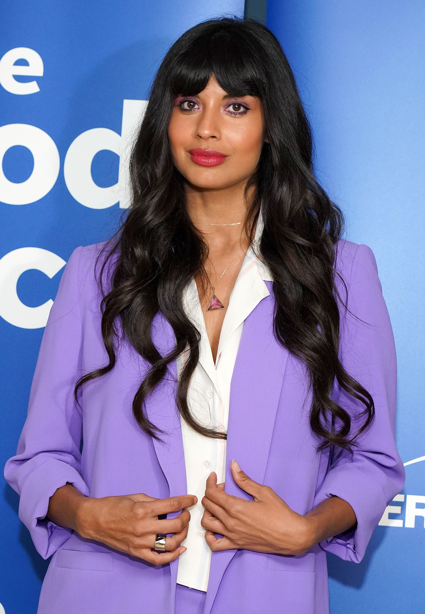 Jameela Jamil Wearing a White Shirt and Purple Jacket and Purple Pants