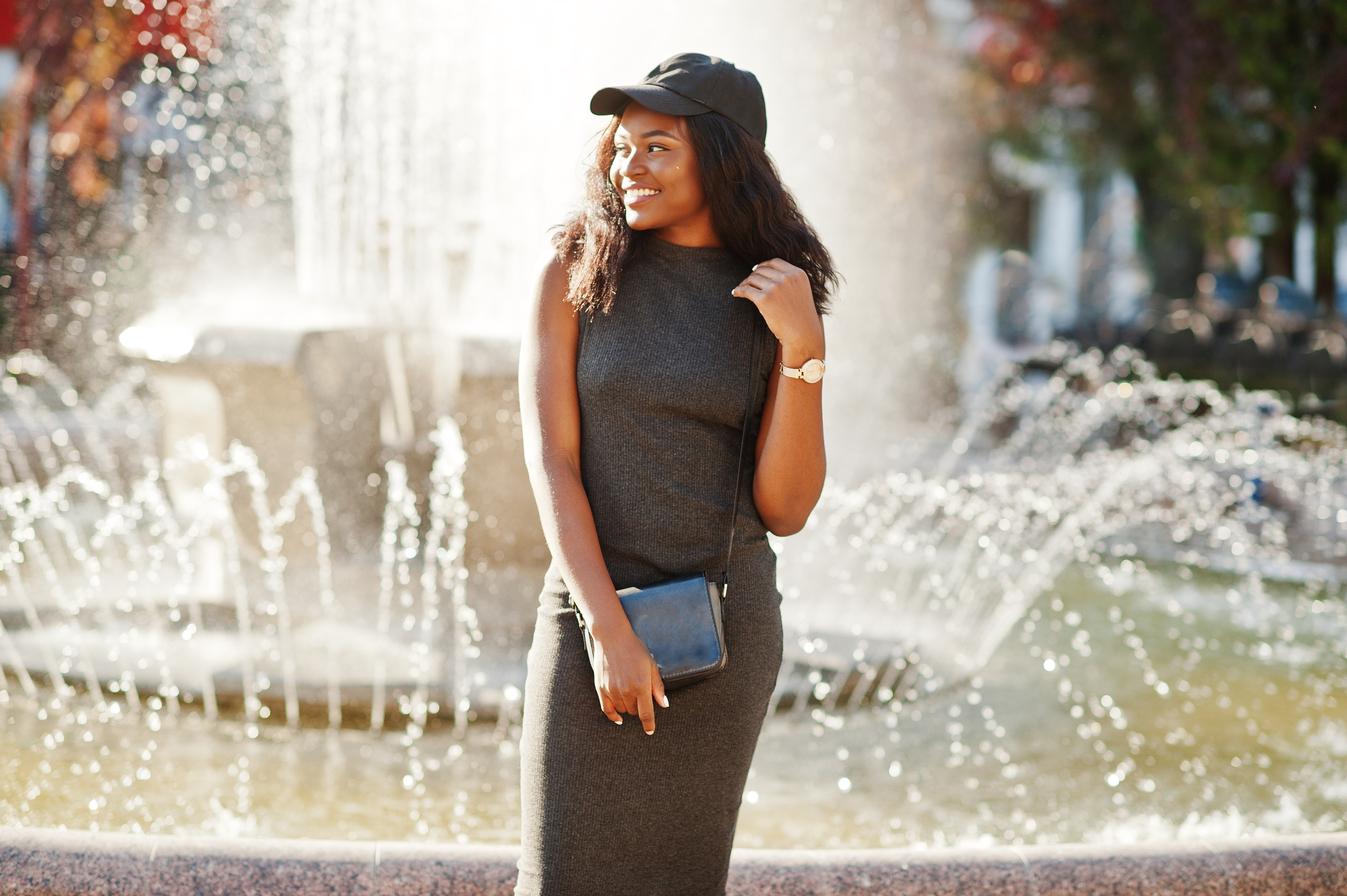 girl standing in front of a fountain