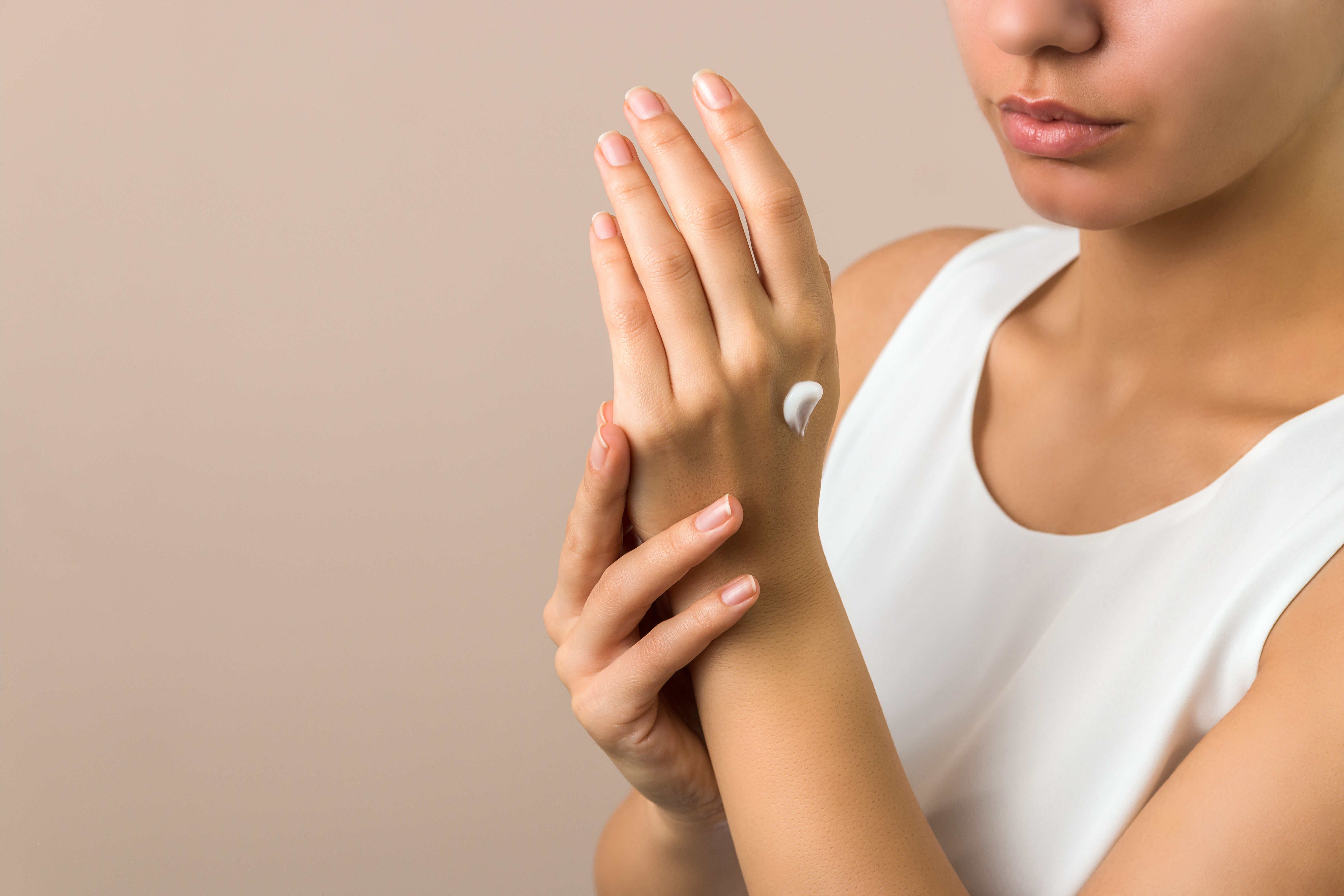 woman moisturizing skin