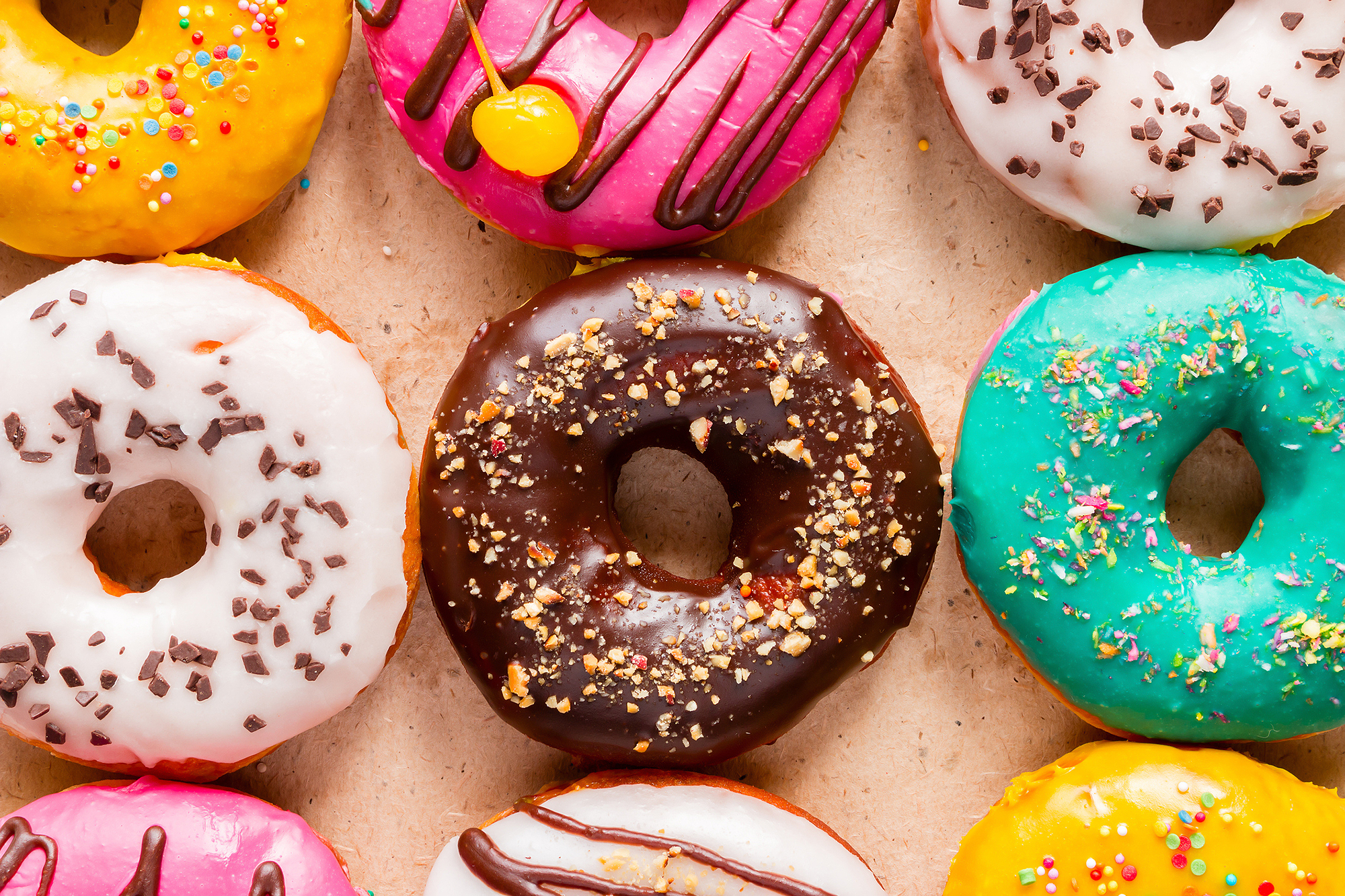 tasty donuts on paper close up