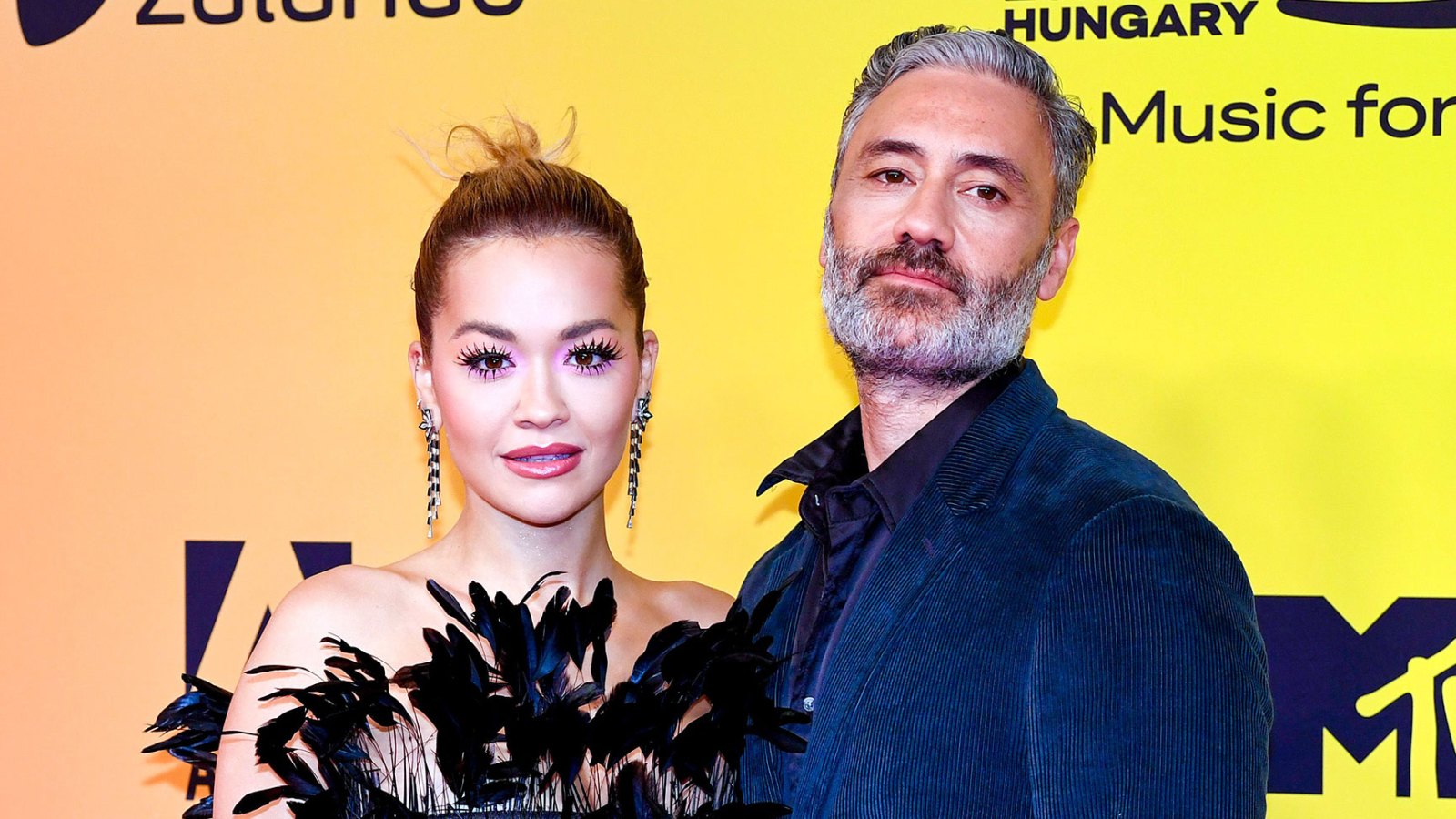 To the Rescue Taika Waititi Fixes Girlfriend Rita Ora’s Dress on 2021 EMAs Red Carpet