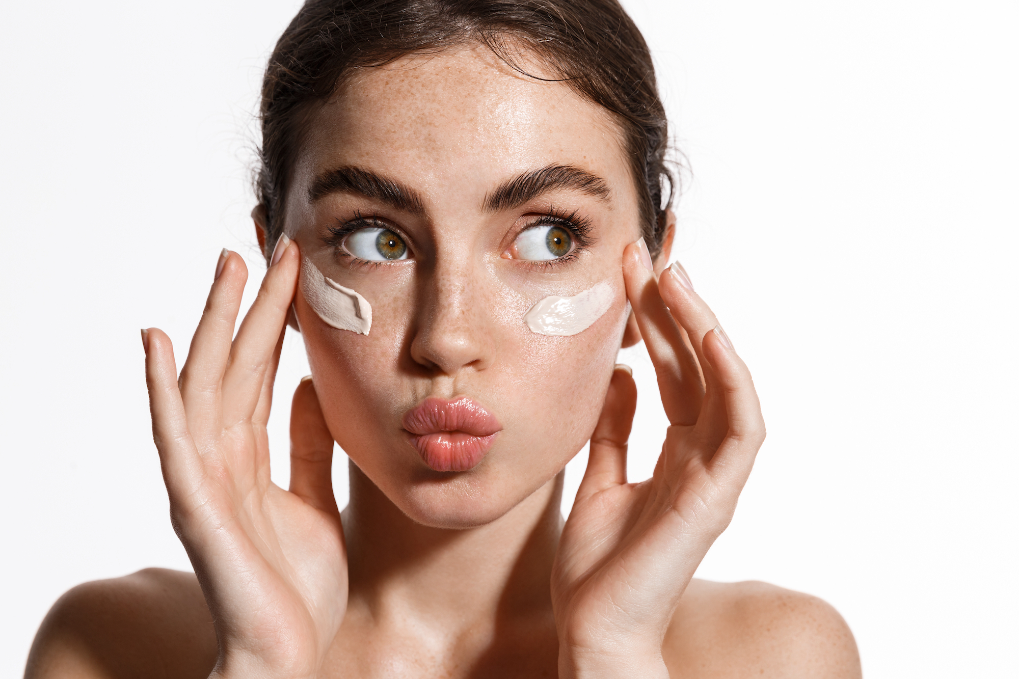 Woman-Applying-Moisturizer-Stock-Photo