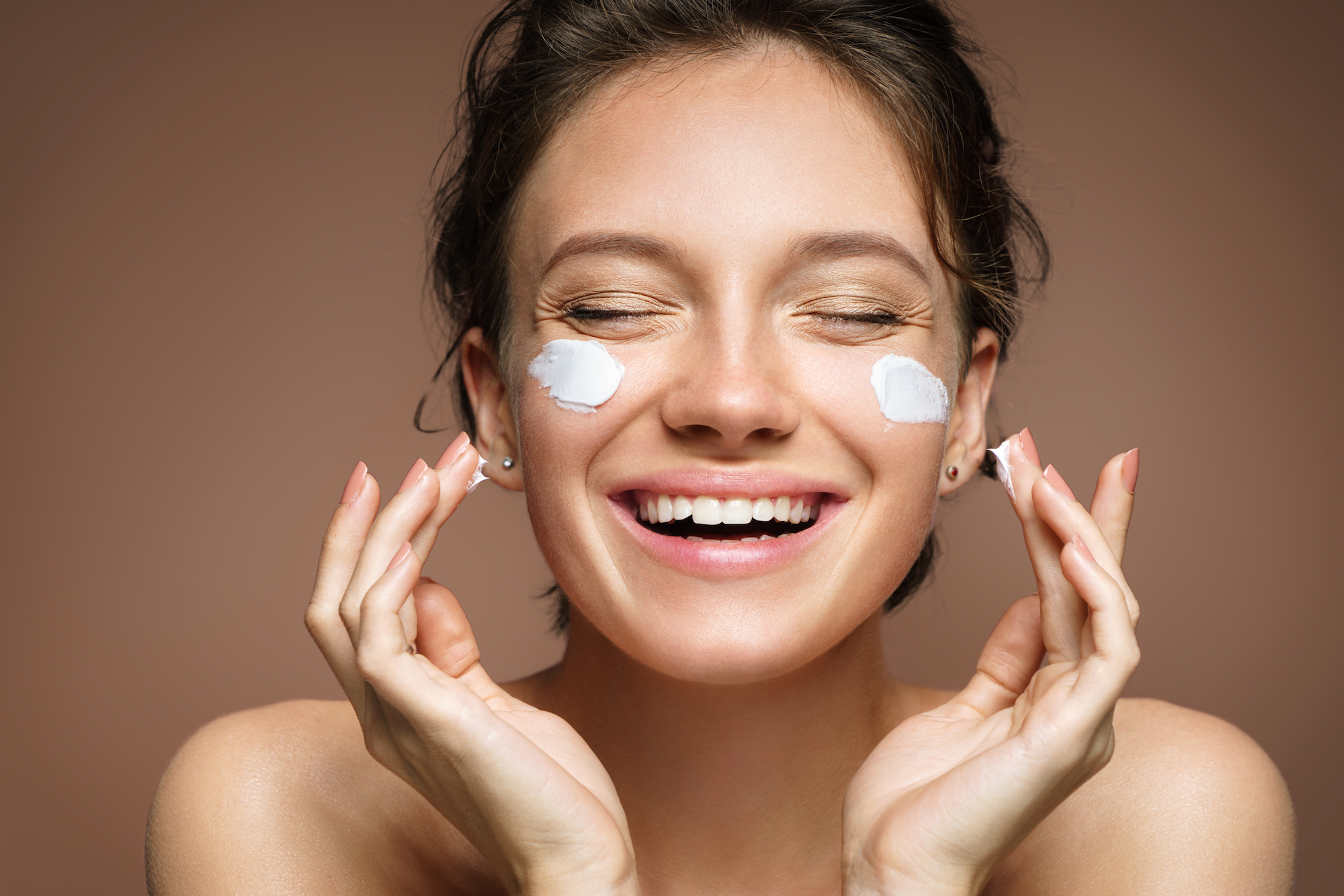 Woman-Applying-Moisturizer-Stock-Photo