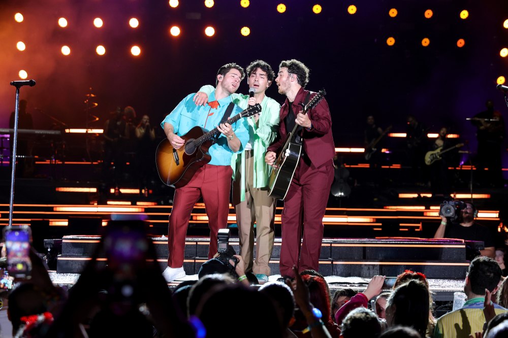 Joe Jonas Hugs Brothers Kevin and Nick During The Tour