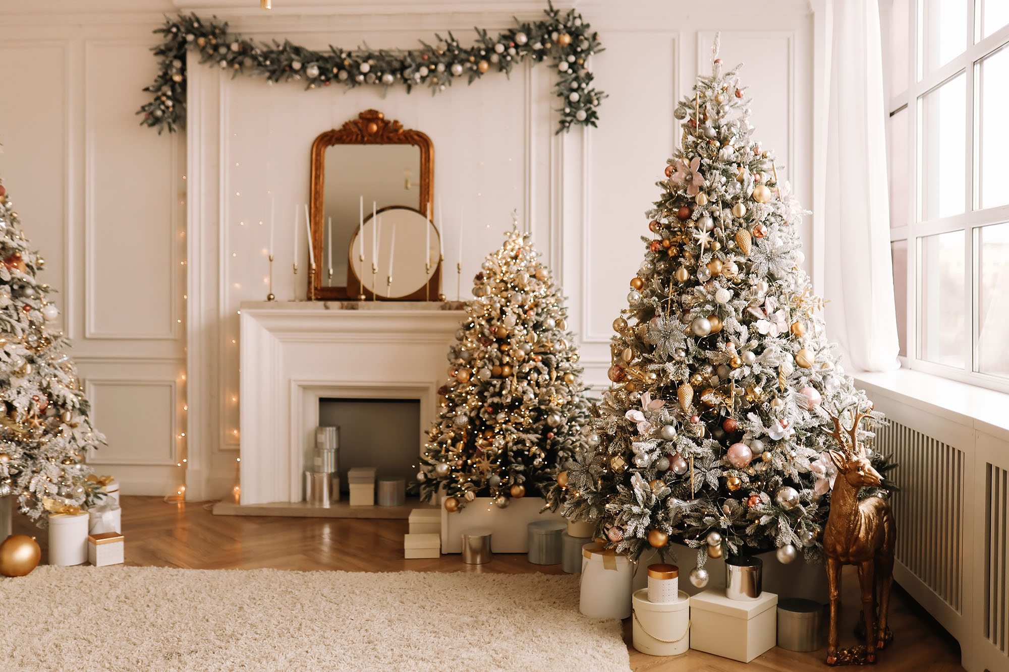 Christmas concept. Festive Christmas rich interior in a luxurious modern style with a fireplace and decorated with Christmas balls and garlands of Christmas trees in a large bright living room in the apartment on New Year's Eve in winter.