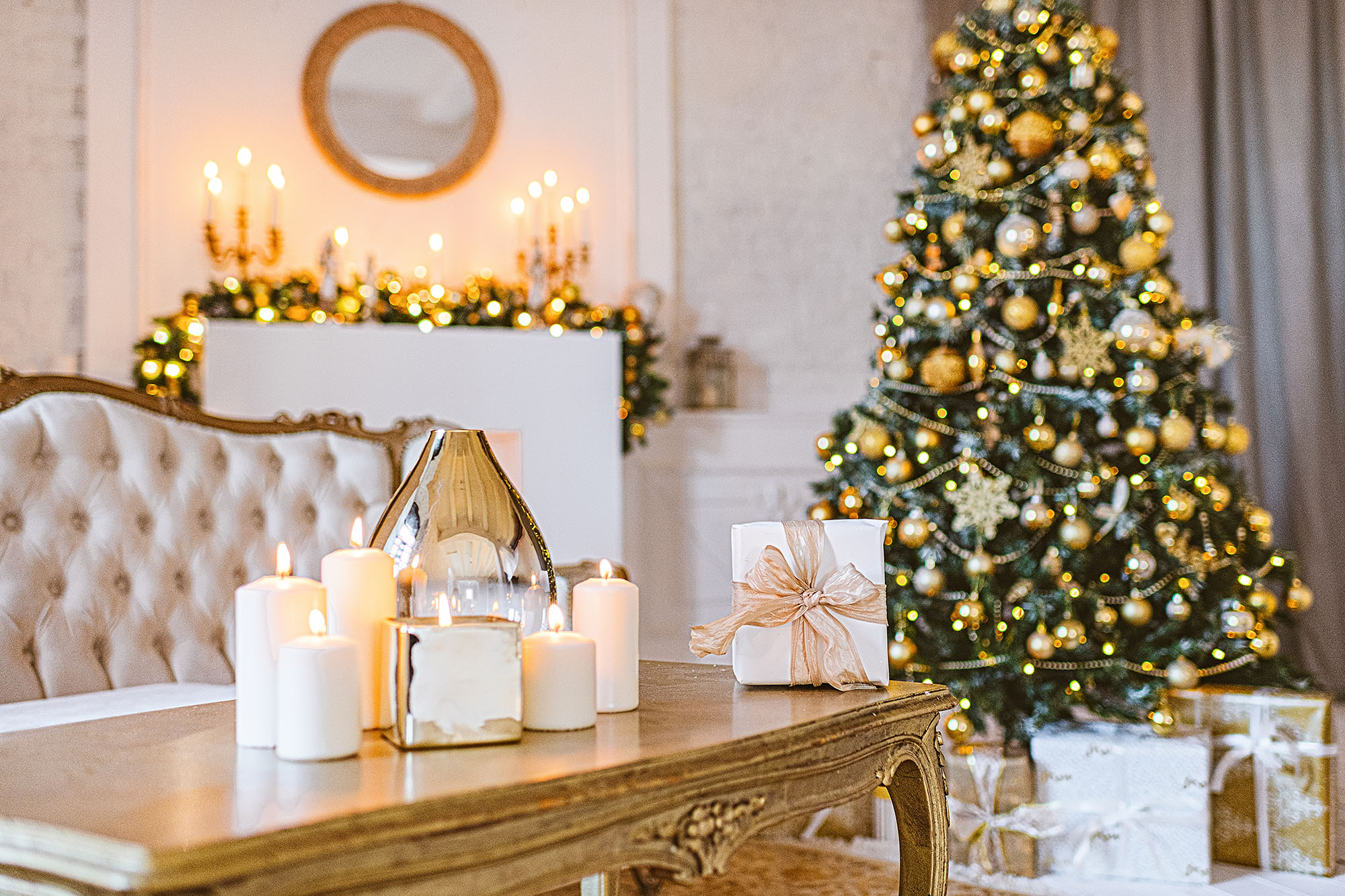 Christmas living room decoration, white and gold colors interior decoration background, Xmas home decoration with presents, christmas lights and tree indoors