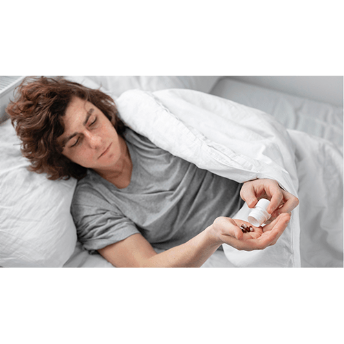 Young man taking sleeping pills