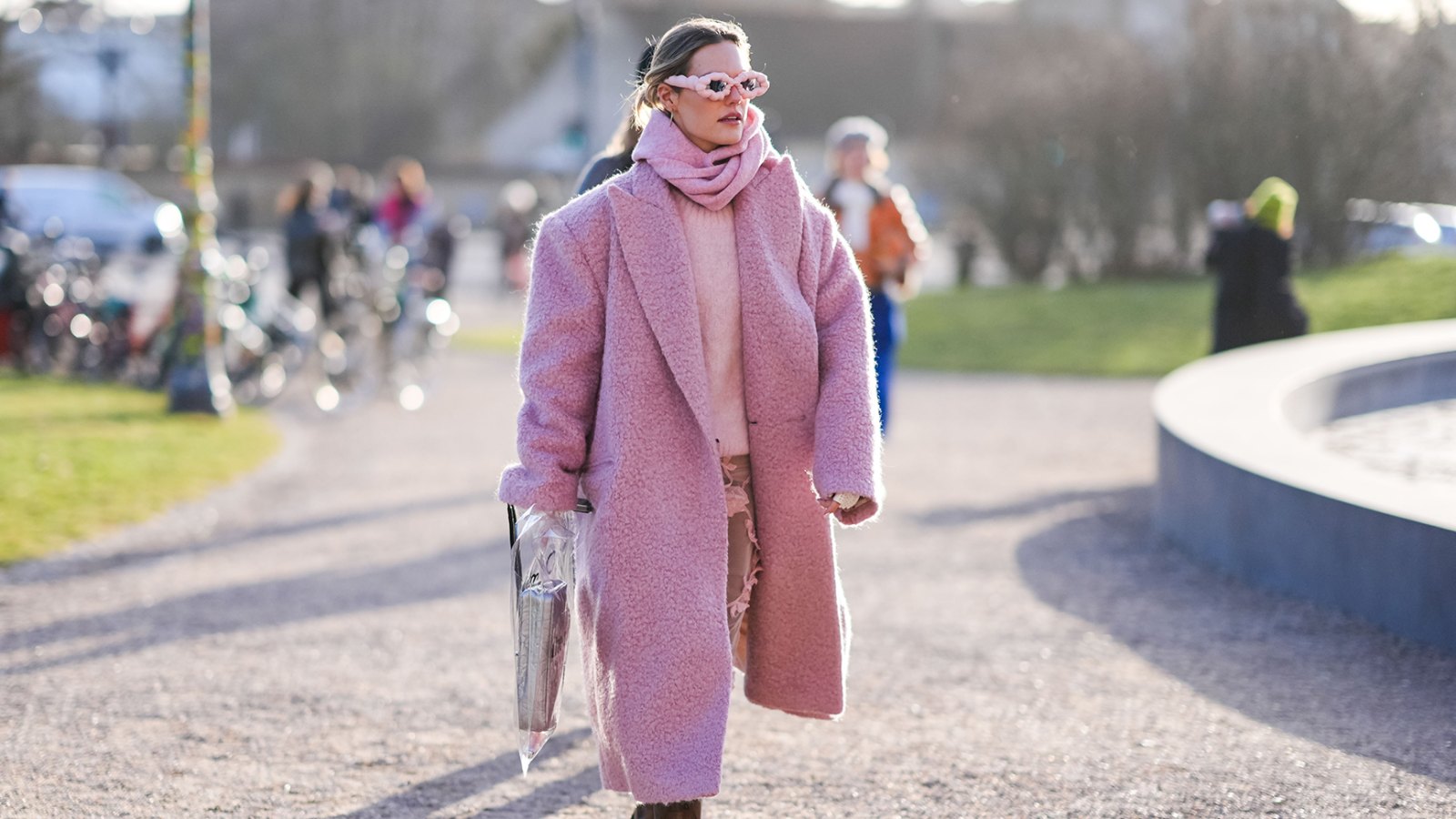 COPENHAGEN, DENMARK - FEBRUARY 01: A guest wears a pink full outfit, sunglasses, a fluffy long oversized blazer jacket , a pullover leather boots , outside Marimekko, during the Copenhagen Fashion Week AW24 on February 01, 2024 in Copenhagen, Denmark. (Photo by Edward Berthelot/Getty Images)