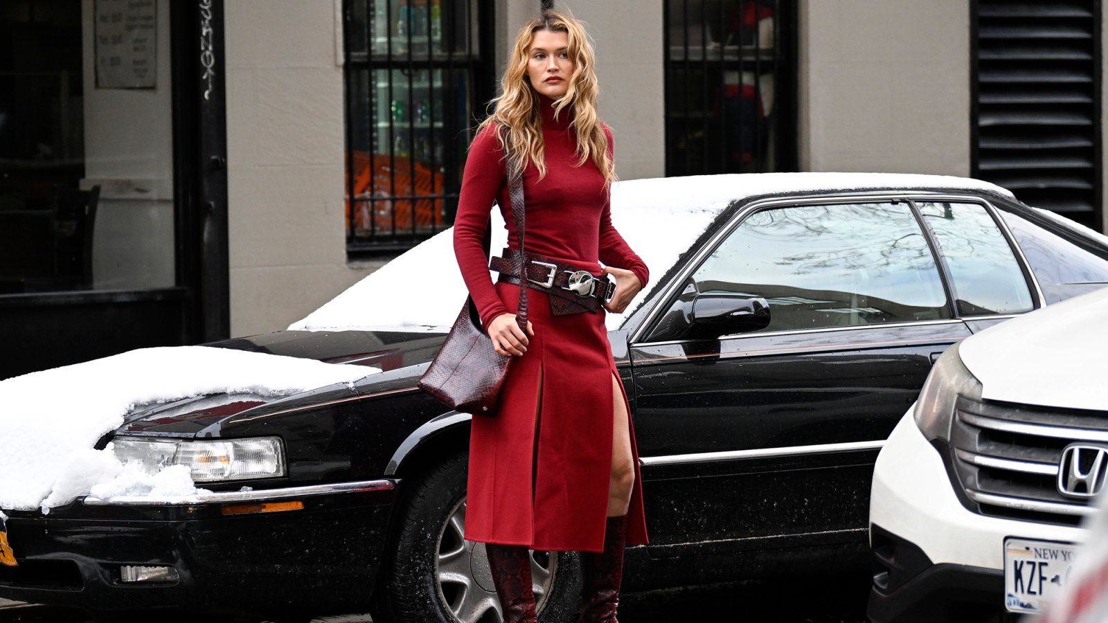 Chloe Lecareux is seen wearing a red Michael Kors dress, maroon and silver belt, maroon boots and maroon bag outside the Michael Kors show during NYFW F/W 2024 on February 13, 2024 in New York City. (Photo by Daniel Zuchnik/Getty Images)