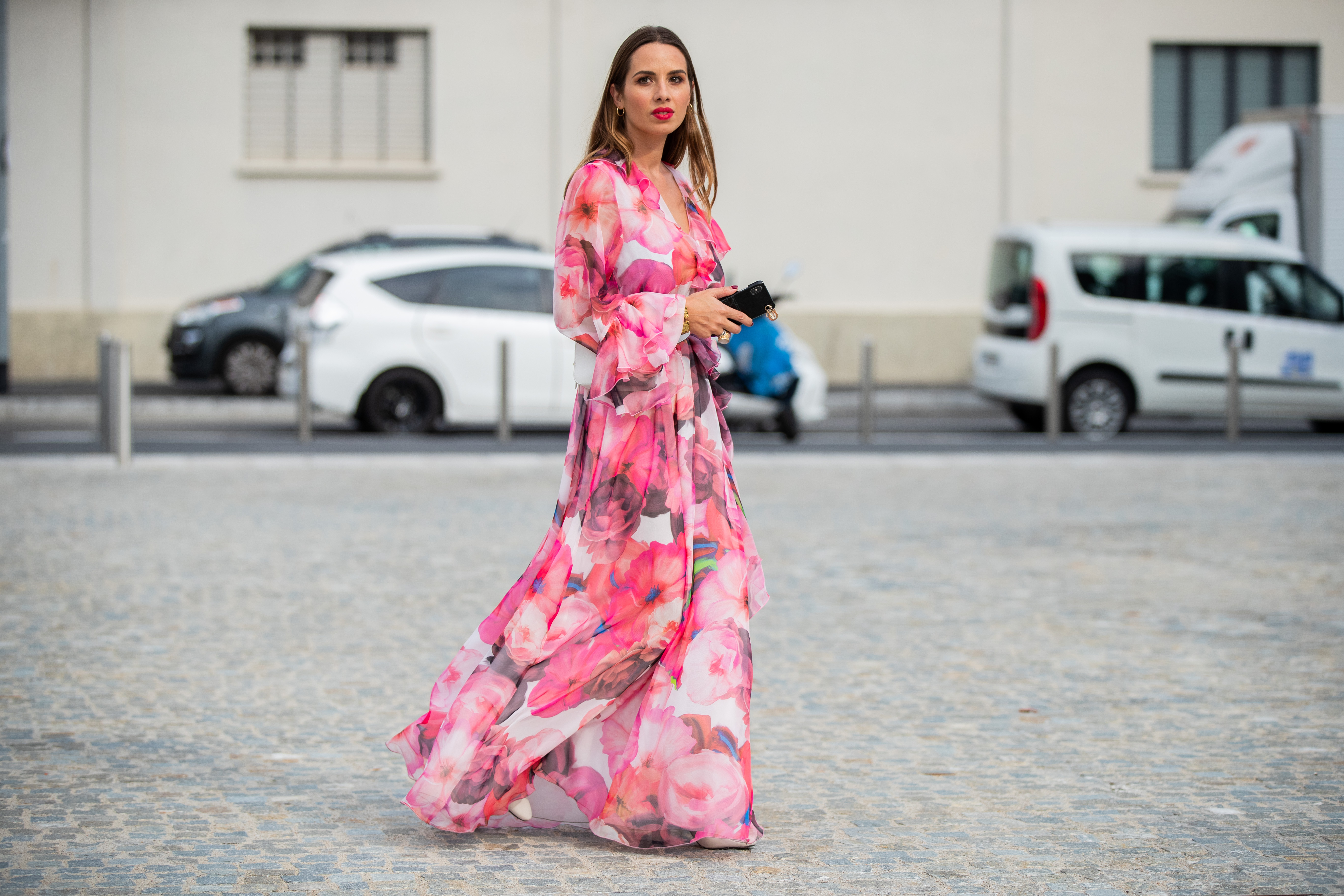 Maria Rosaria Rizzo is seen wearing a pink dress with floral print MSGM, white Furla fanny belt bag, Jonak boots during Milan Fashion Week Spring/Summer 2020 on September 18, 2019 in Milan, Italy.