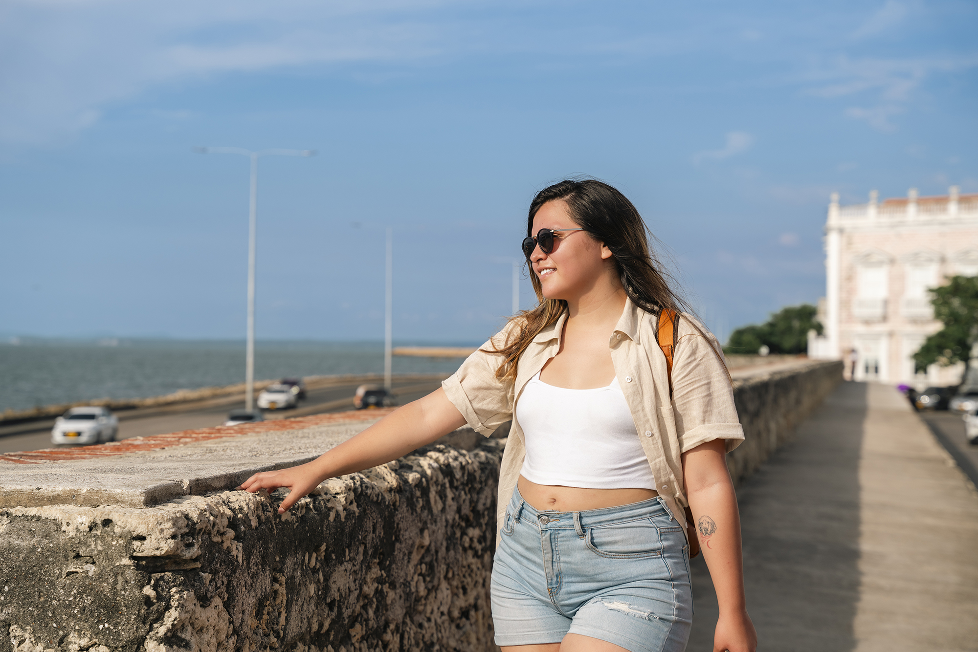 A Traveling Woman in a leather backpack explores the tropical and wonderful Cartagena