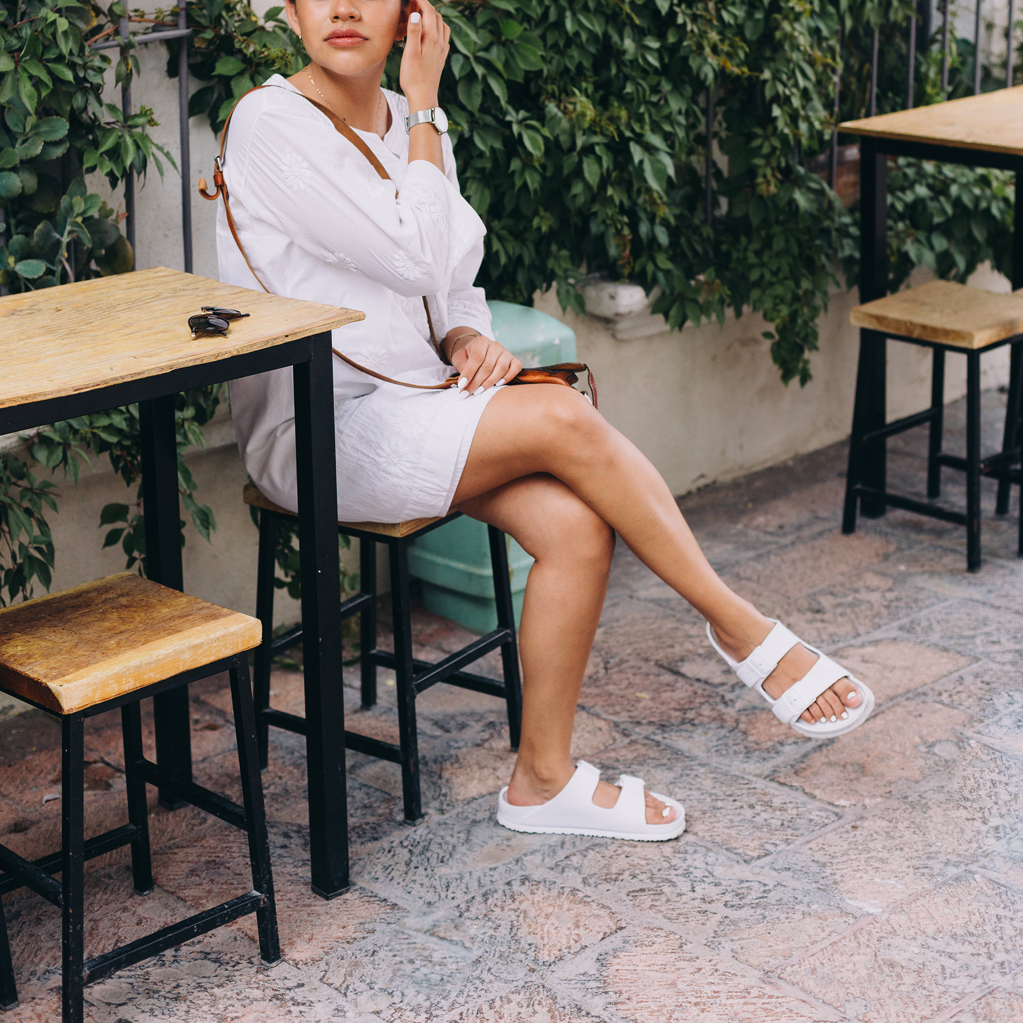 Young woman in casual clothing in sidewalk cafe in Mexico
