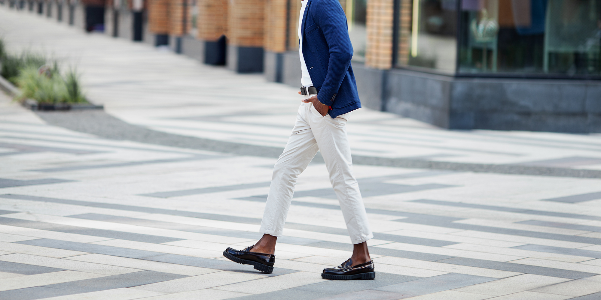 Man walks down the street in loafers.
