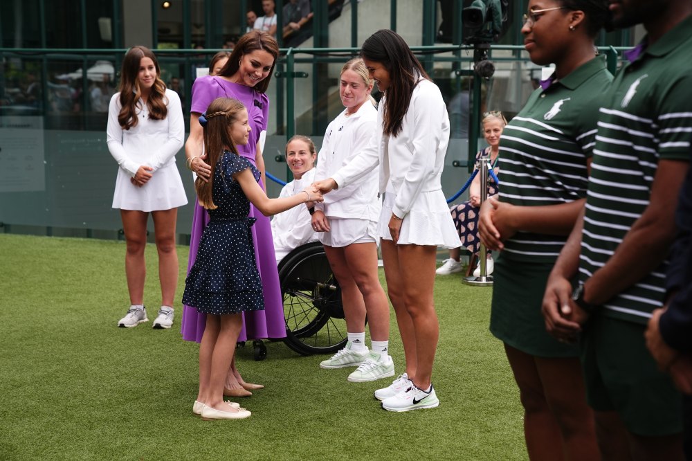 LONDON, ENGLAND - JULY 14: Catherine, Princess of Wales and Princess Charlotte meet Emma Raducanu (R) during a visit to the All England Lawn Tennis and Croquet Club in Wimbledon, south west London, on day fourteen of the Wimbledon Tennis Championships on July 14, 2024 in London, England. The Princess of Wales will present the trophy to the winner of the men's final. (Photo by Aaron Chown - WPA Pool/Getty Images)