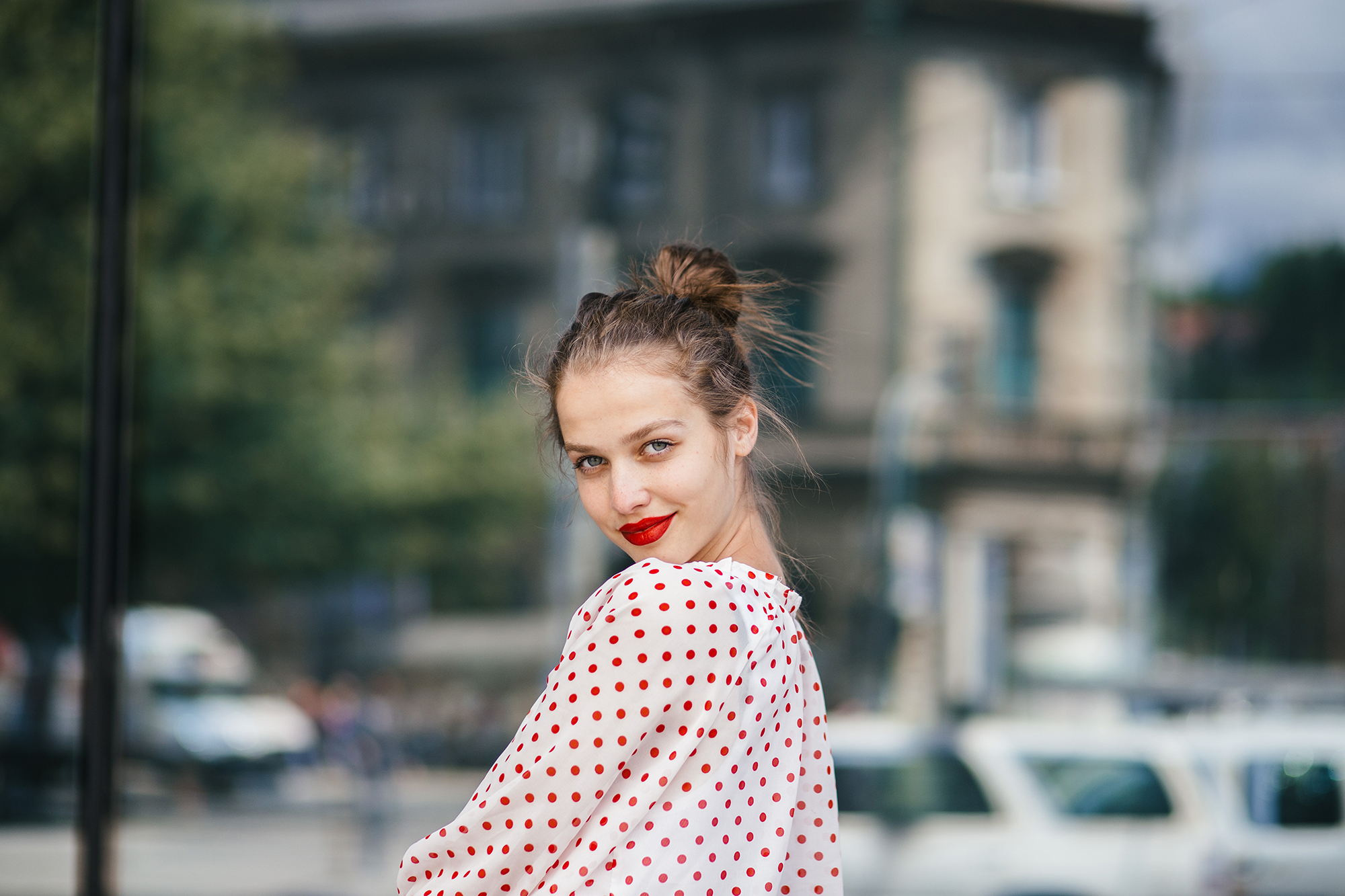 Young beautiful woman in the city wearing red lipstick