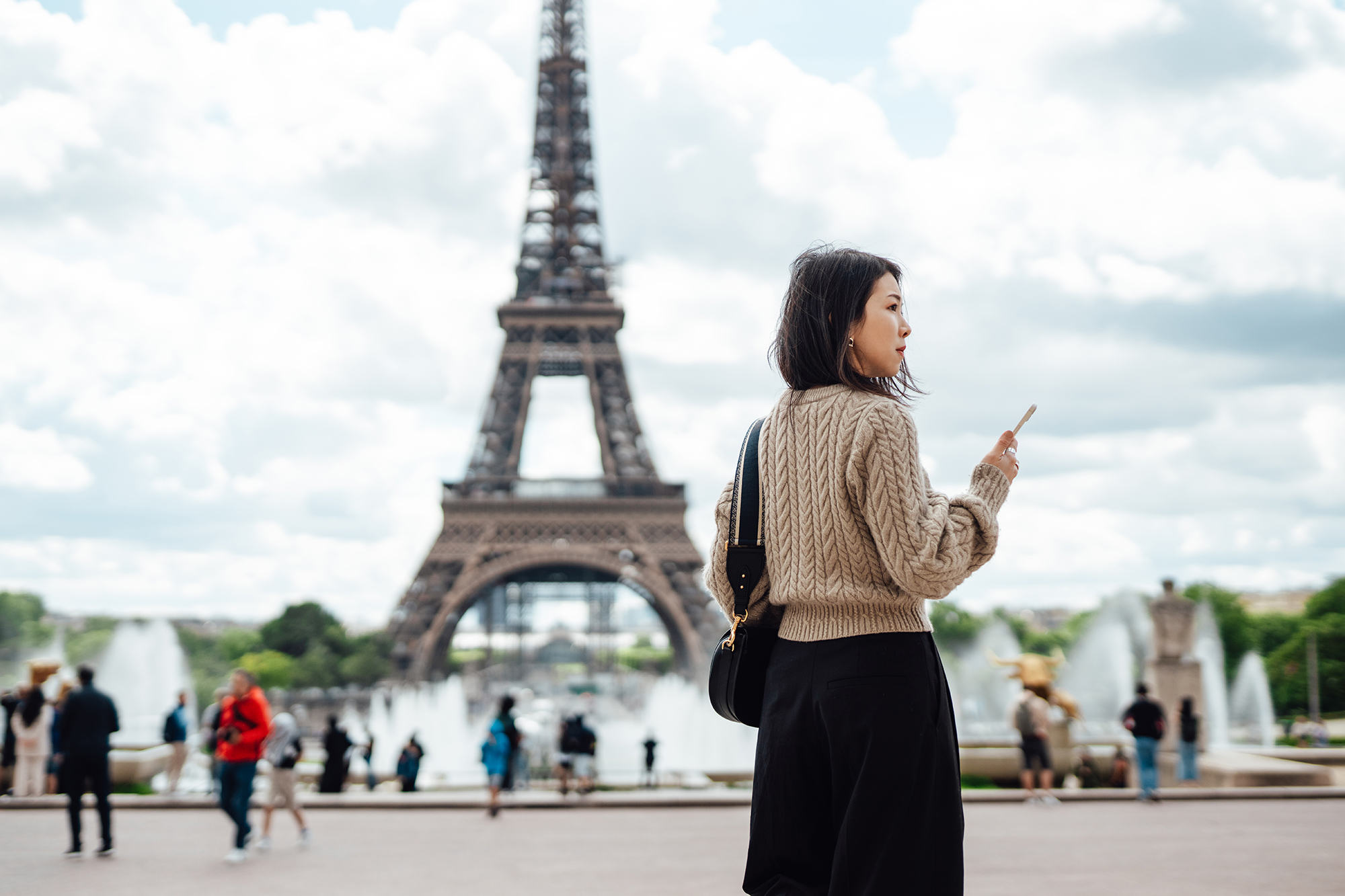 Young business woman working on smartphone during business trip. Business and leisure travel concept.