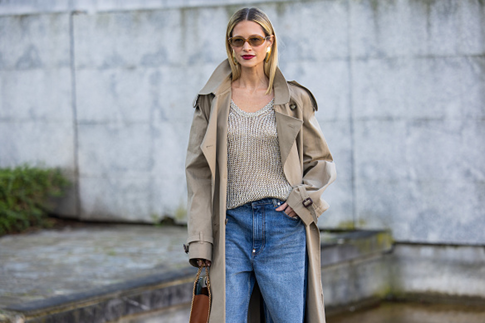 woman wearing beige sweater, jeans and trench coat