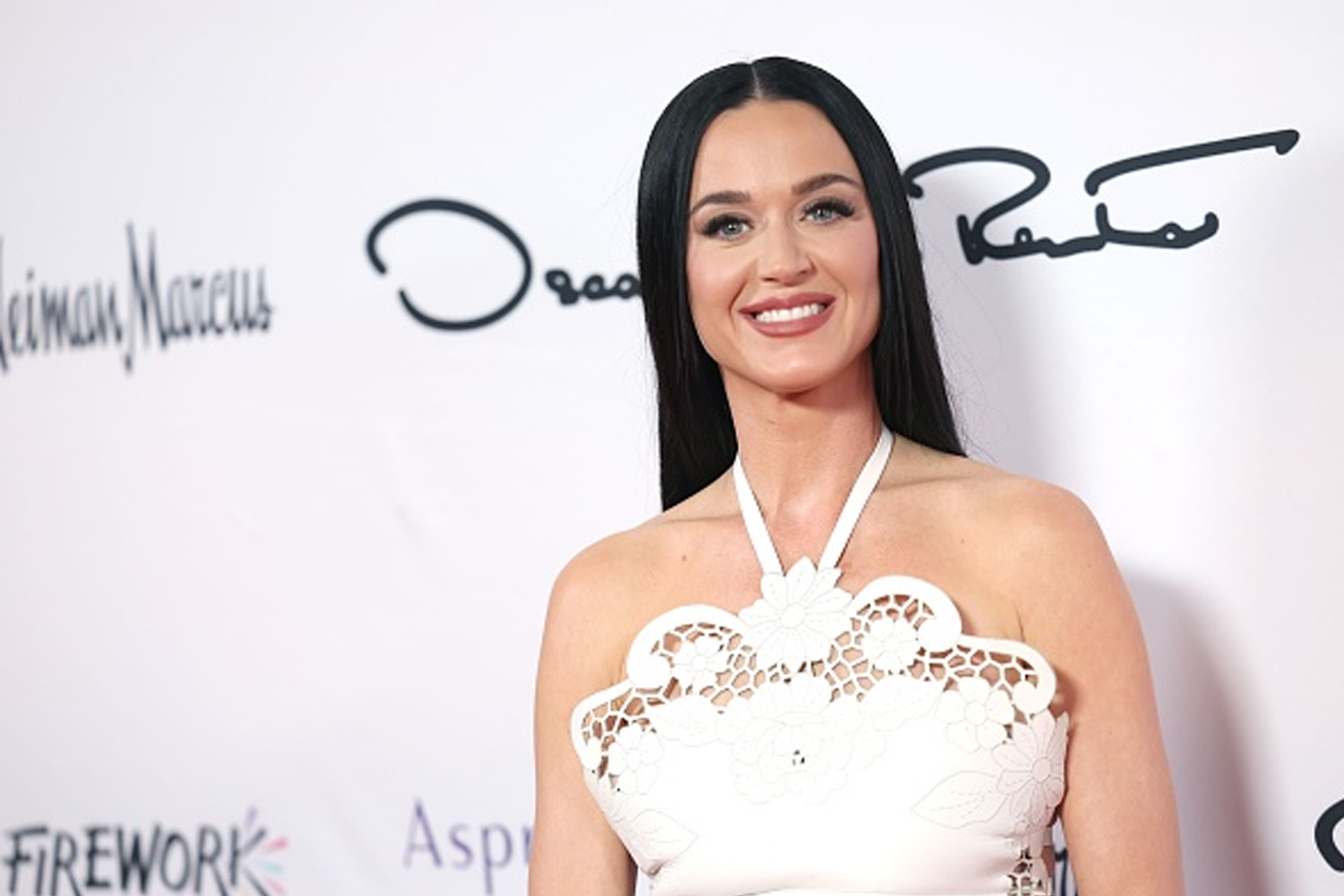 Katy Perry wearing white dress on red carpet