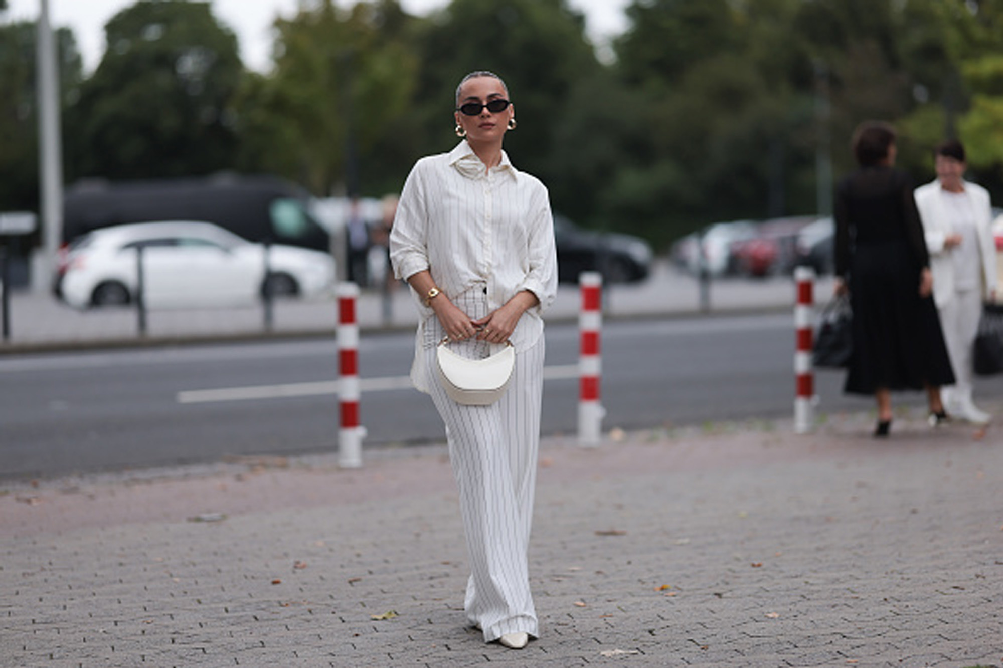 woman wearing striped white matching set on street