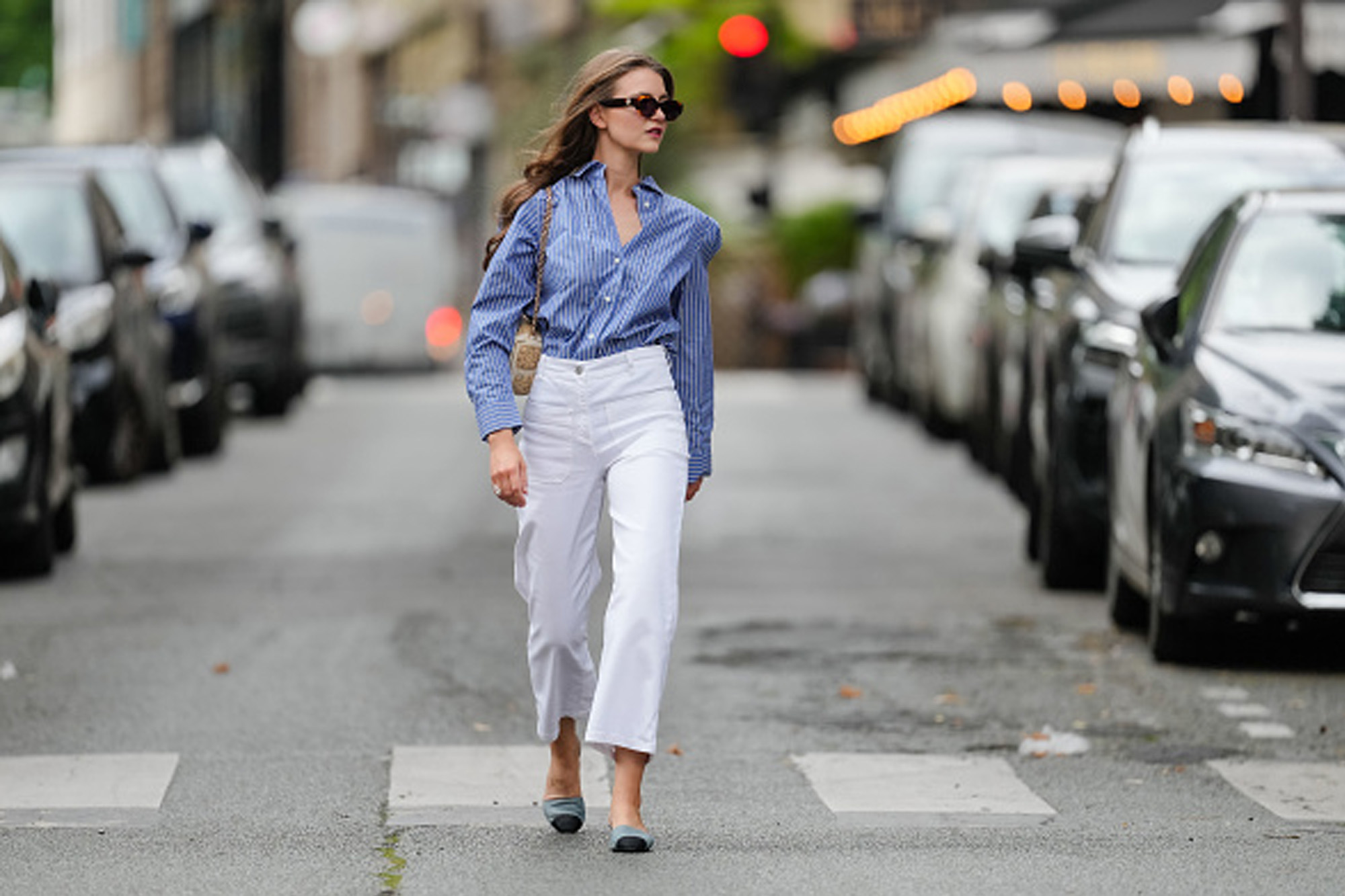 woman wearing white pants and blue button up top