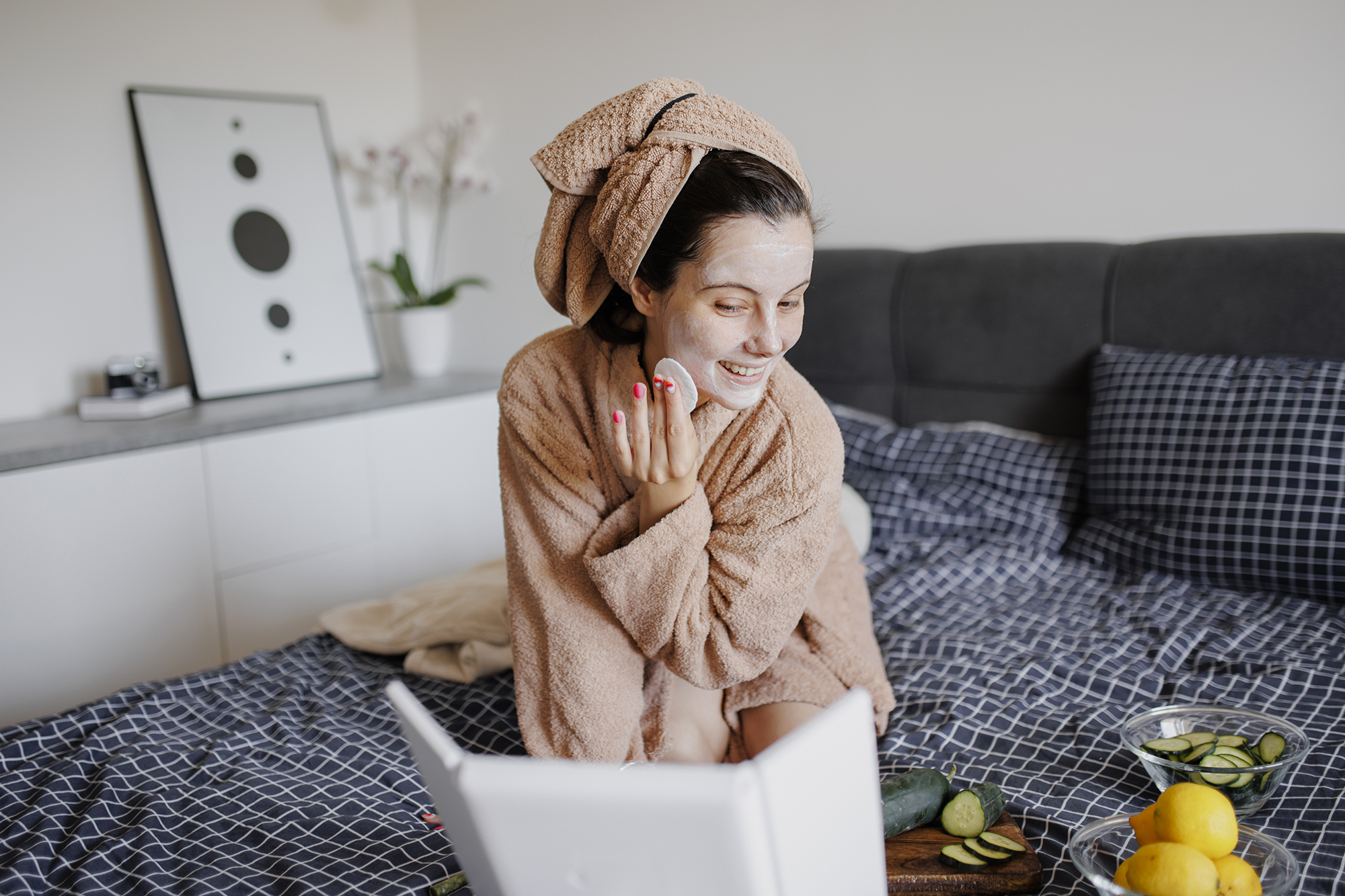 Portrait of woman having skin care routine in bed