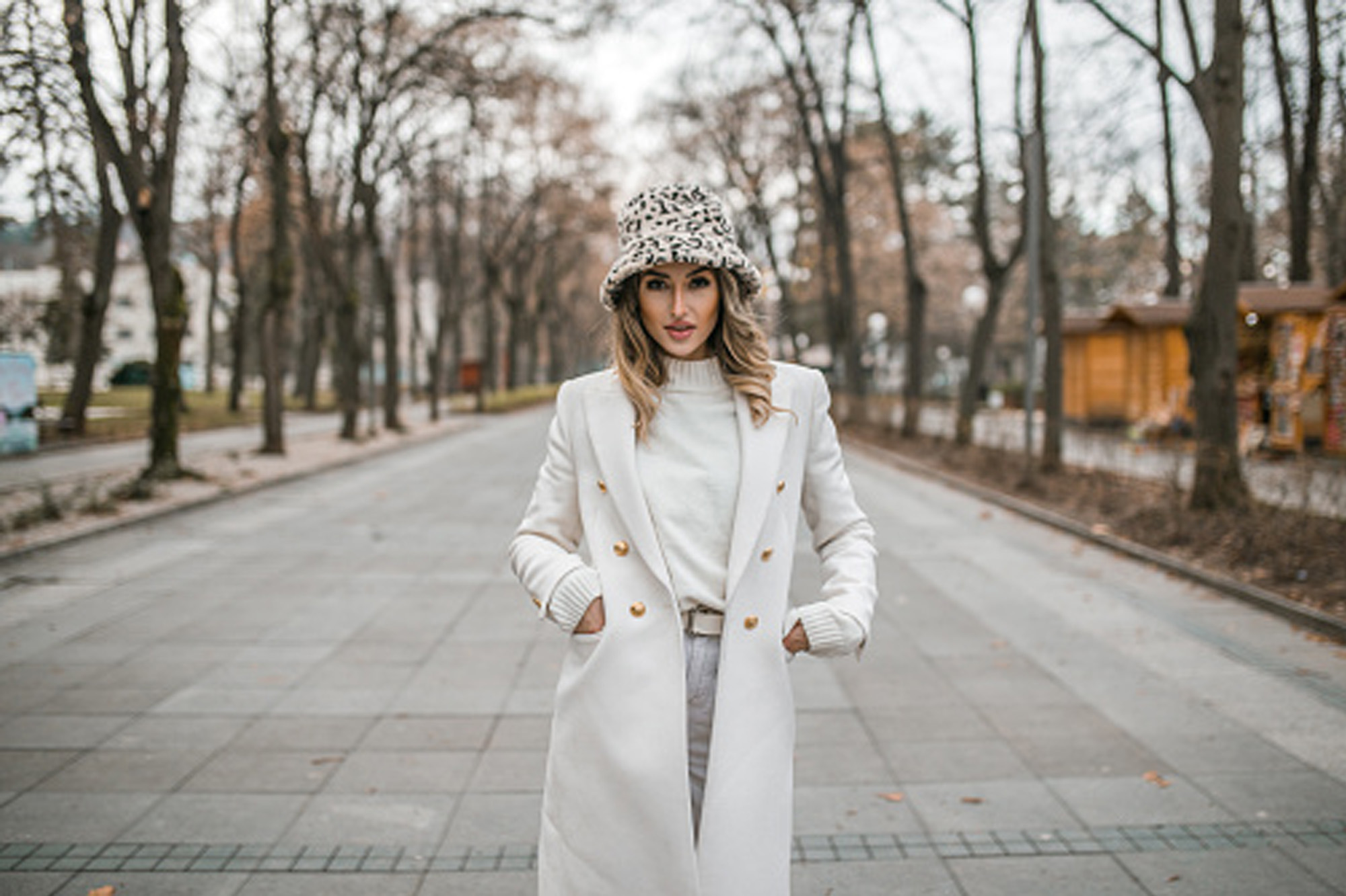 woman wearing white coat in the fall
