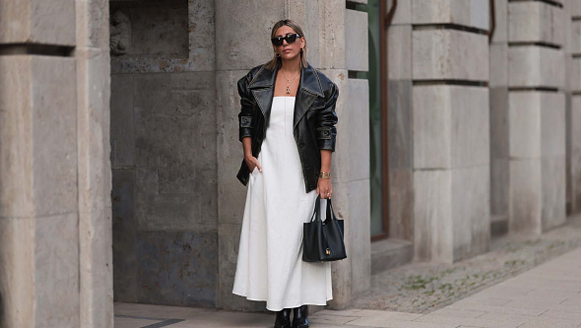 woman wearing white fall dress with black coat