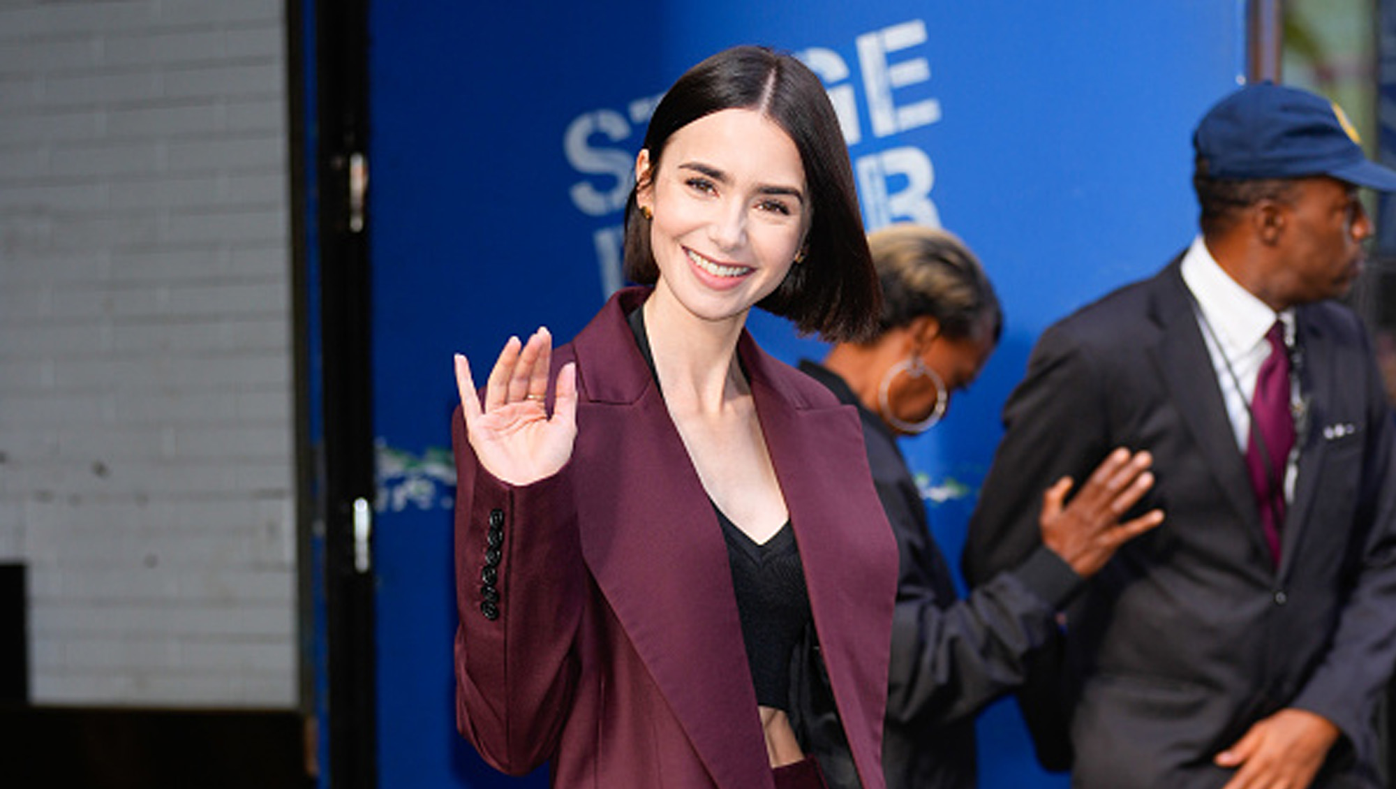 Lily Collins in burgundy suit
