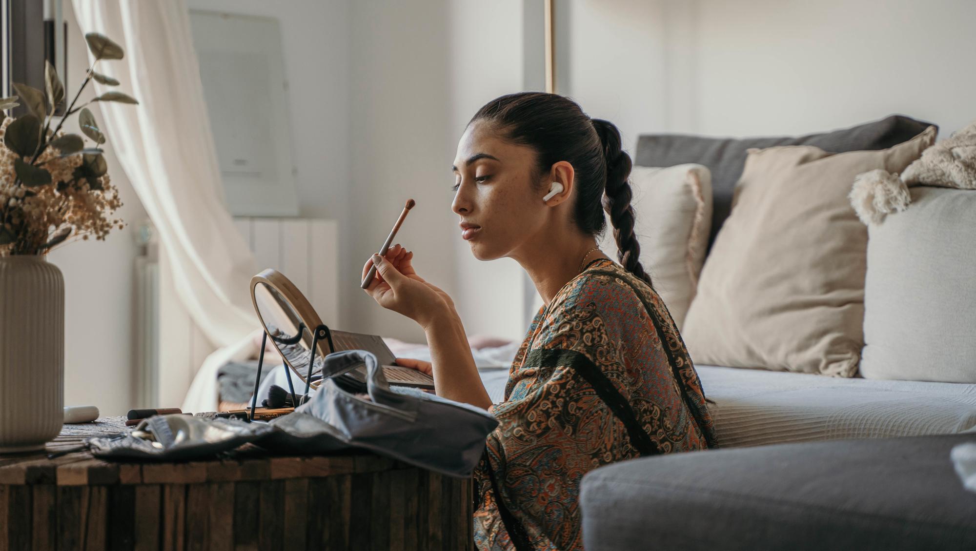 a woman applying makeup in the bedroom
